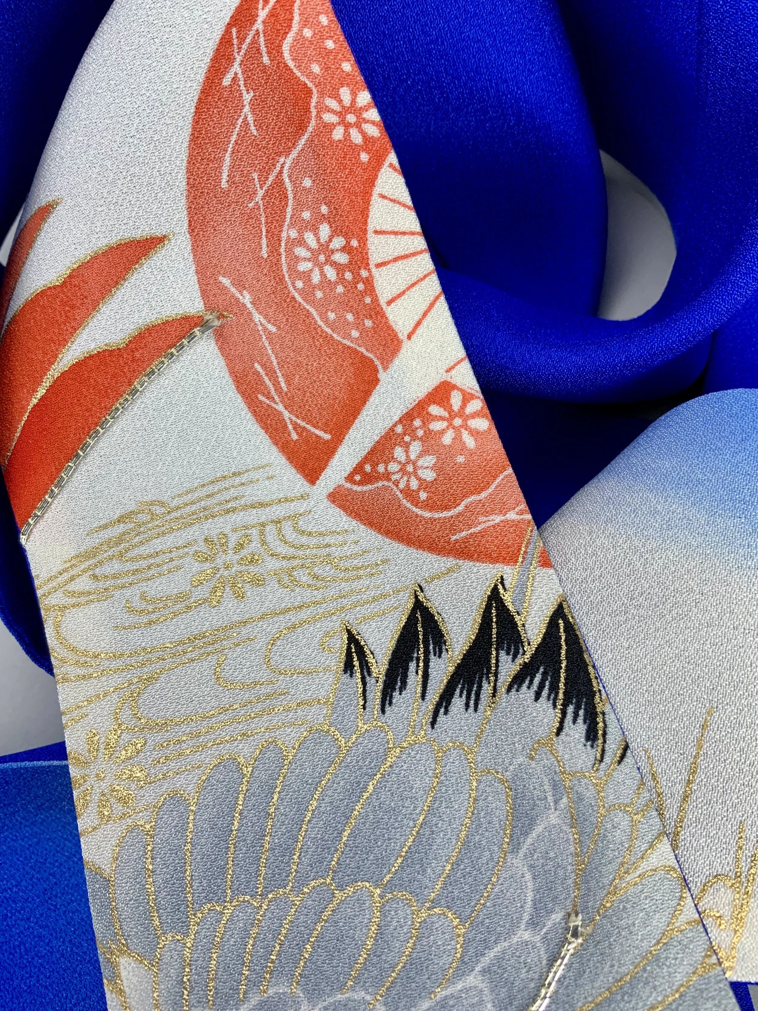 Closeup of blue silk scarf with printed Flying Crane design handmade by Kirsty Chivers