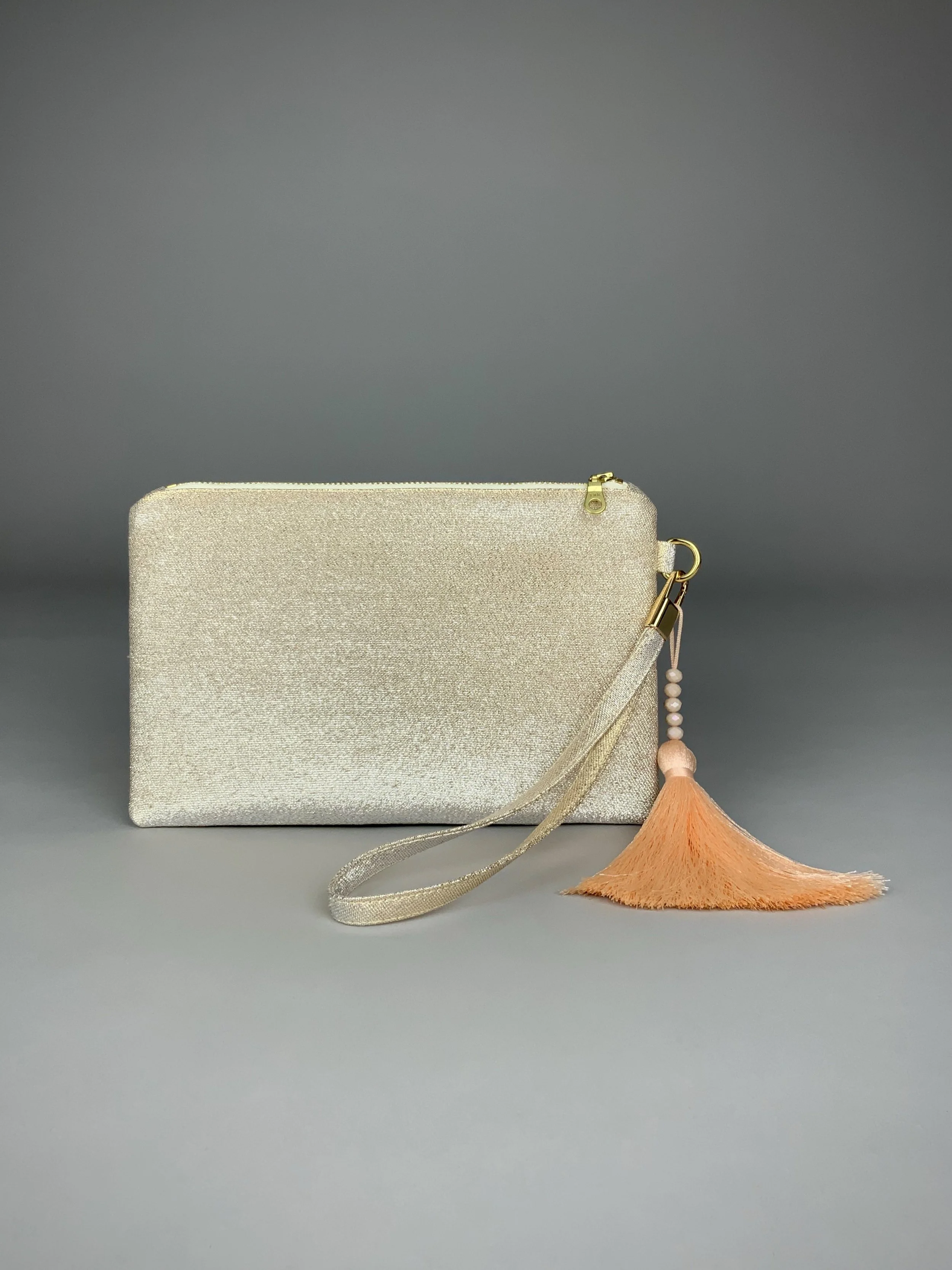 Back view of wristlet purse made from repurposed vintage obi fabric with brushstroke pastel design and gold-silver threads
