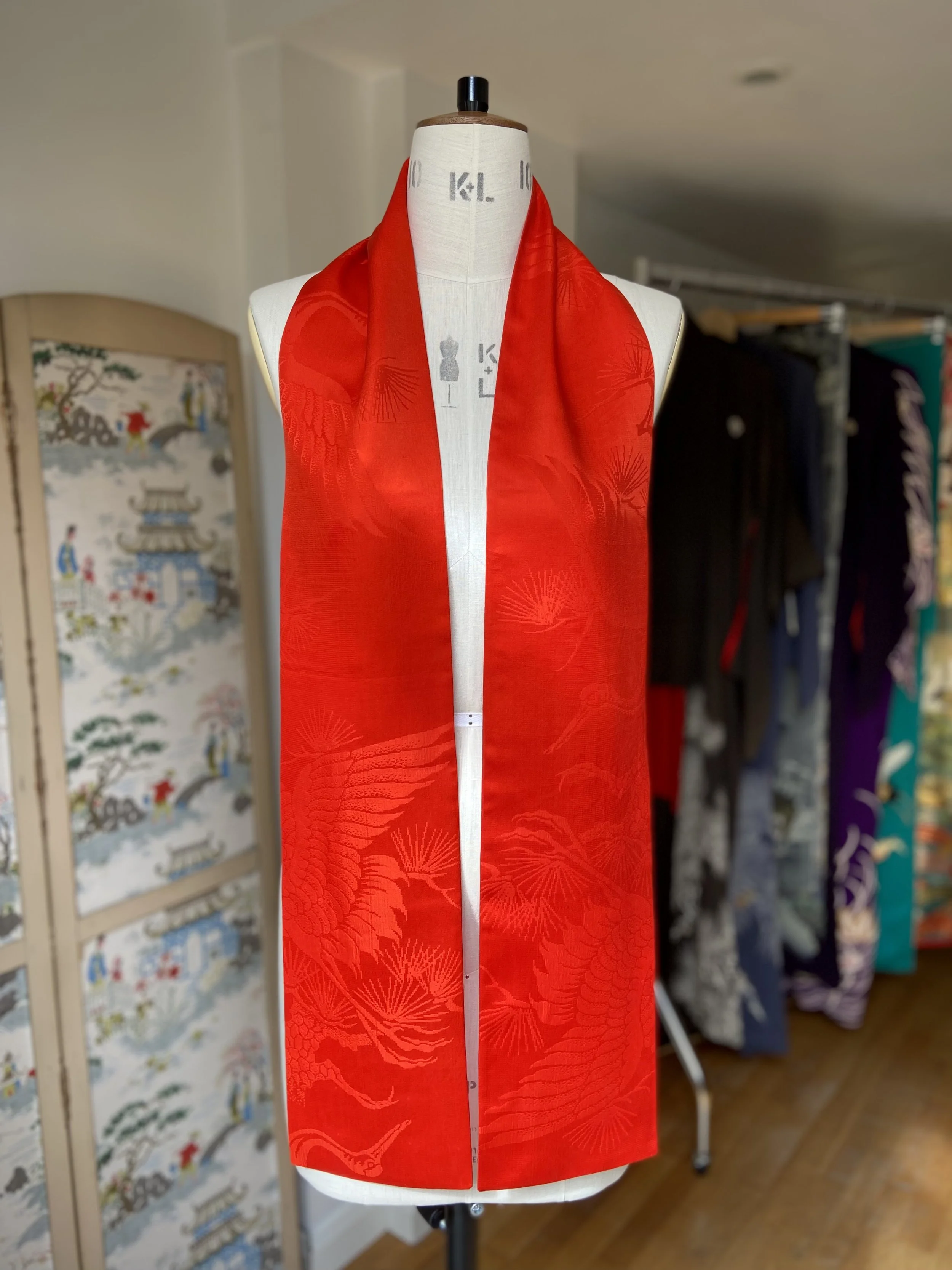 Vibrant vermillion red silk scarf crafted from kimono silk by Kirsty Chivers Handmade, displayed on a dress stand