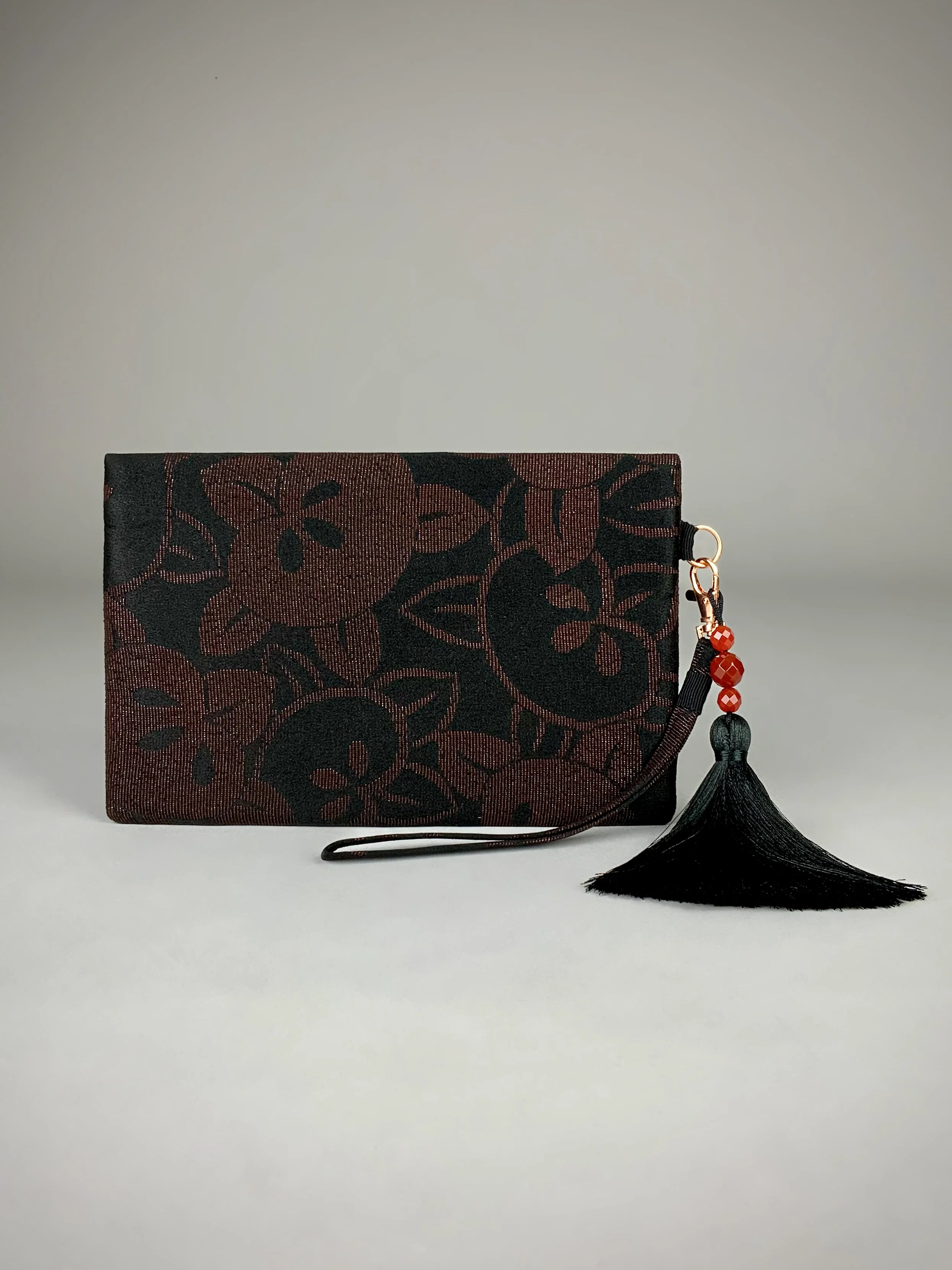 Back view of glittery black evening clutch with tassel made from vintage Japanese kimono silk