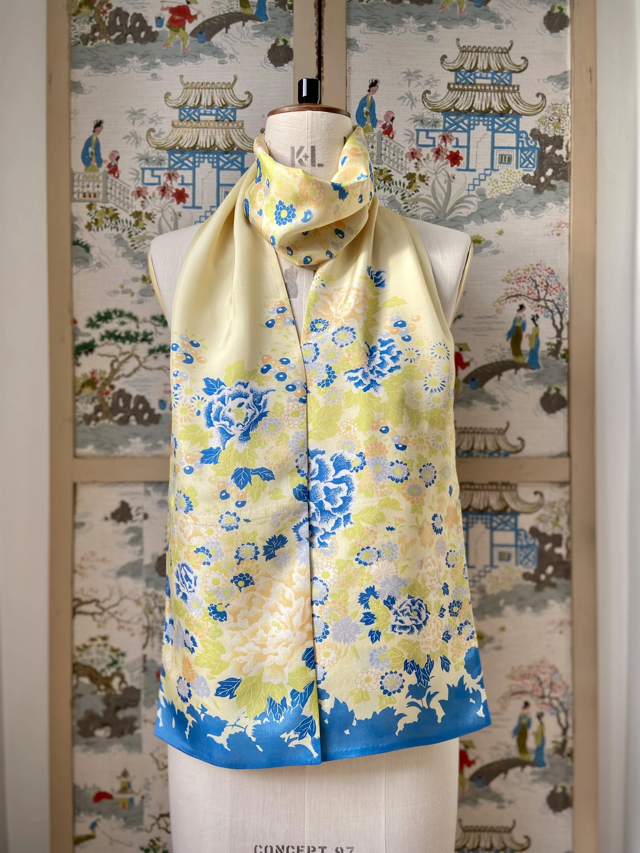 Yellow scarf with blossom print, presented on a dress stand, handmade from vintage kimono fabric and silk satin by Kirsty Chivers