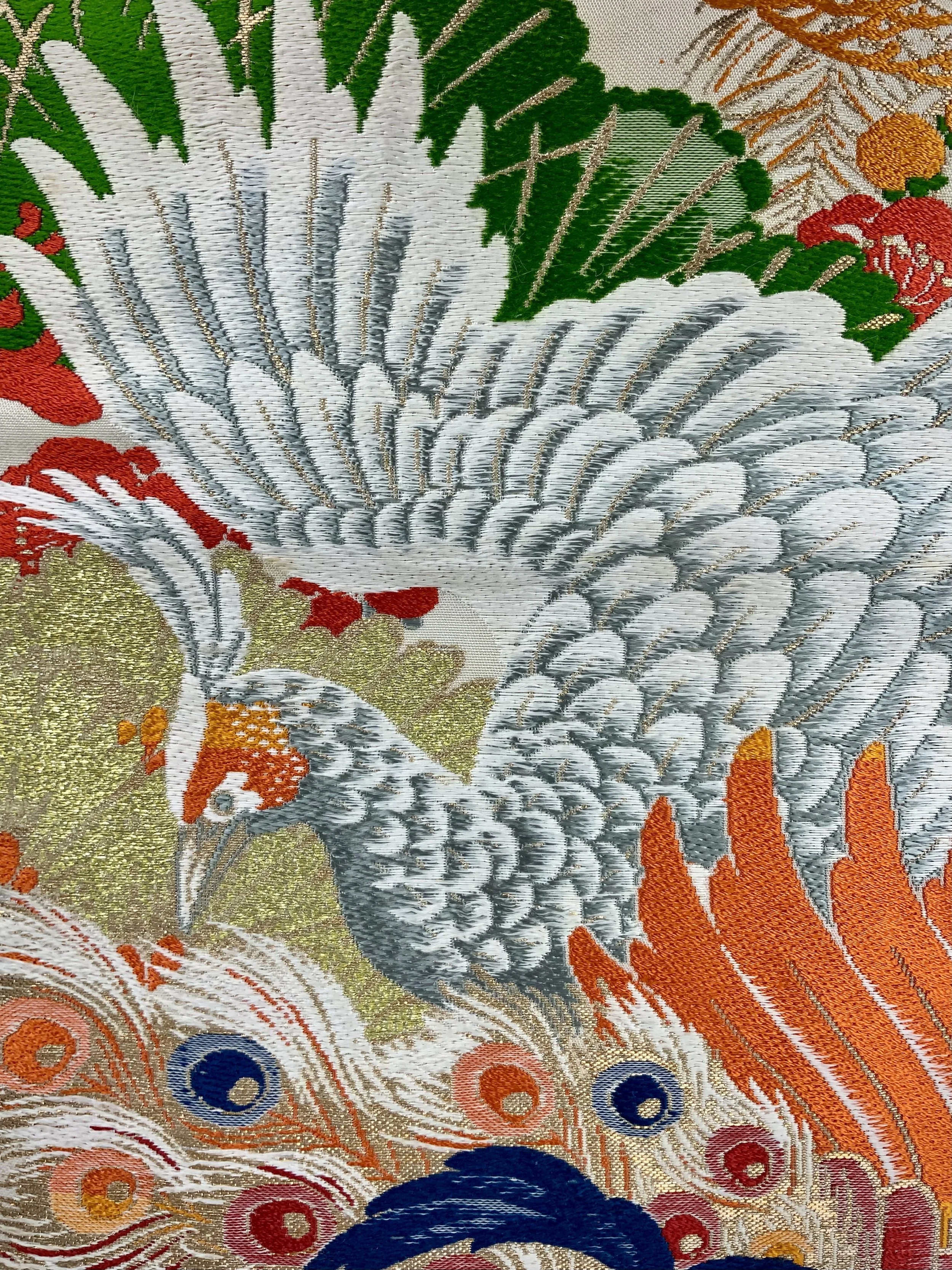 Closeup of one-of-a-kind evening bag in vintage obi silk with peacock, pine motifs & gold accents