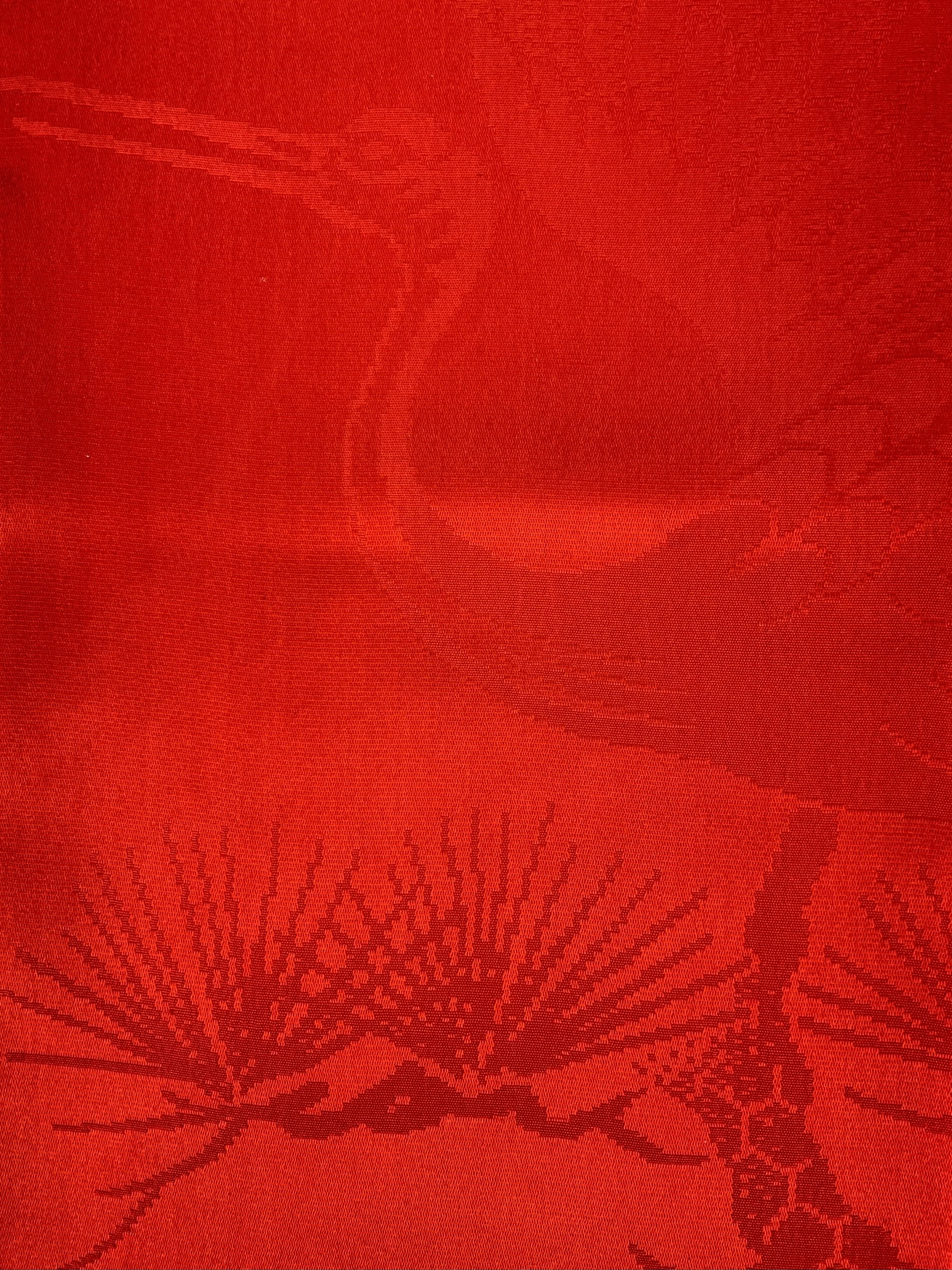 Closeup of a vibrant vermillion red silk scarf crafted from kimono silk by Kirsty Chivers Handmade