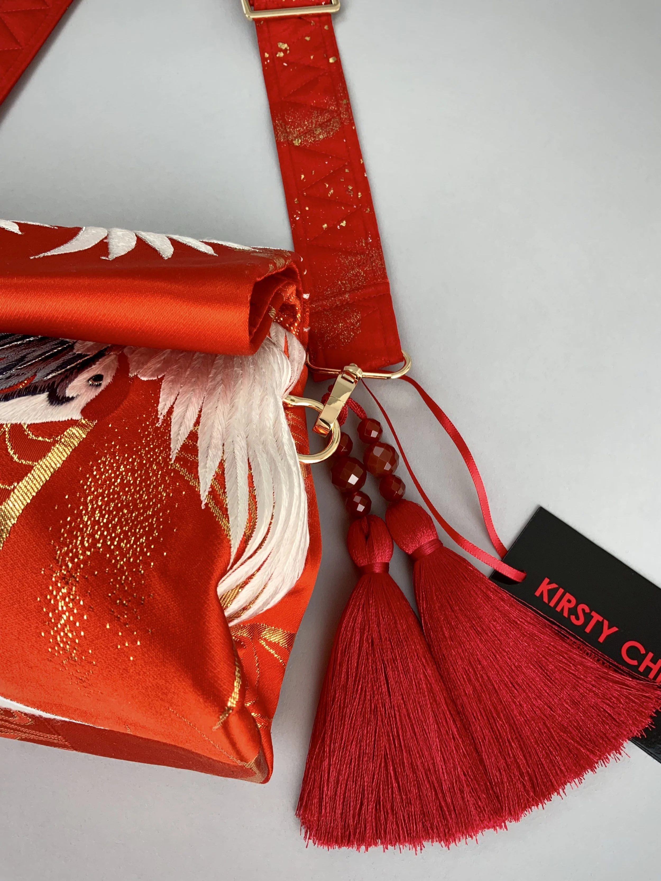 Vermillion red evening bag with embroidered crane design, handmade from vintage kimono silk by Kirsty Chivers