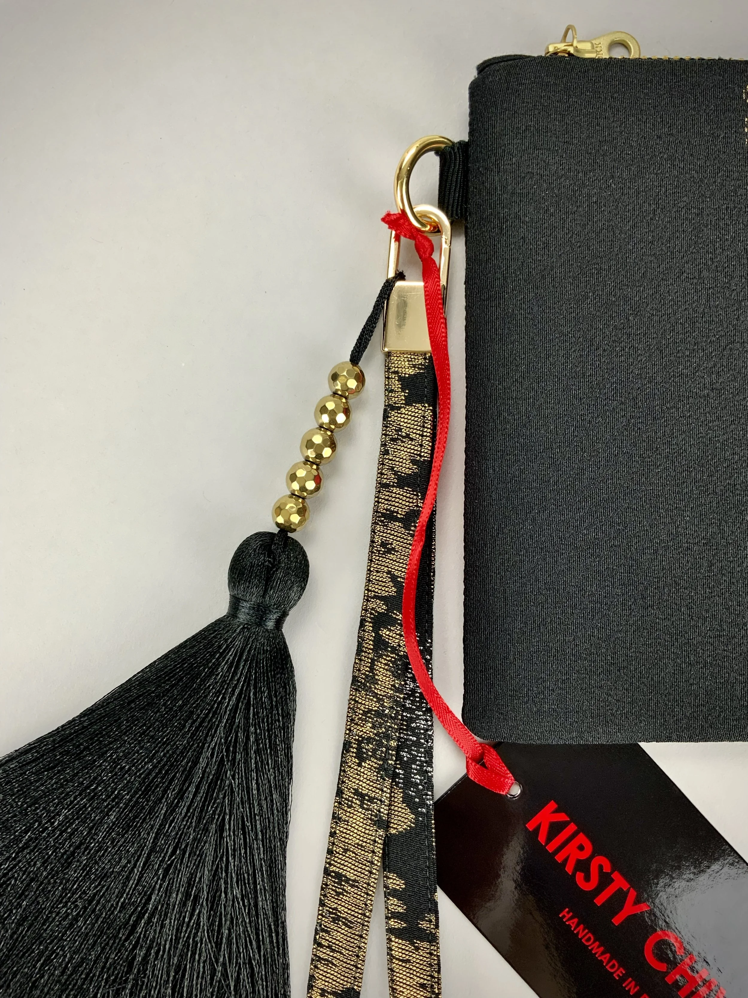 Closeup of wristlet purse made from vintage Japanese Haori silk with gold Urushi thread design