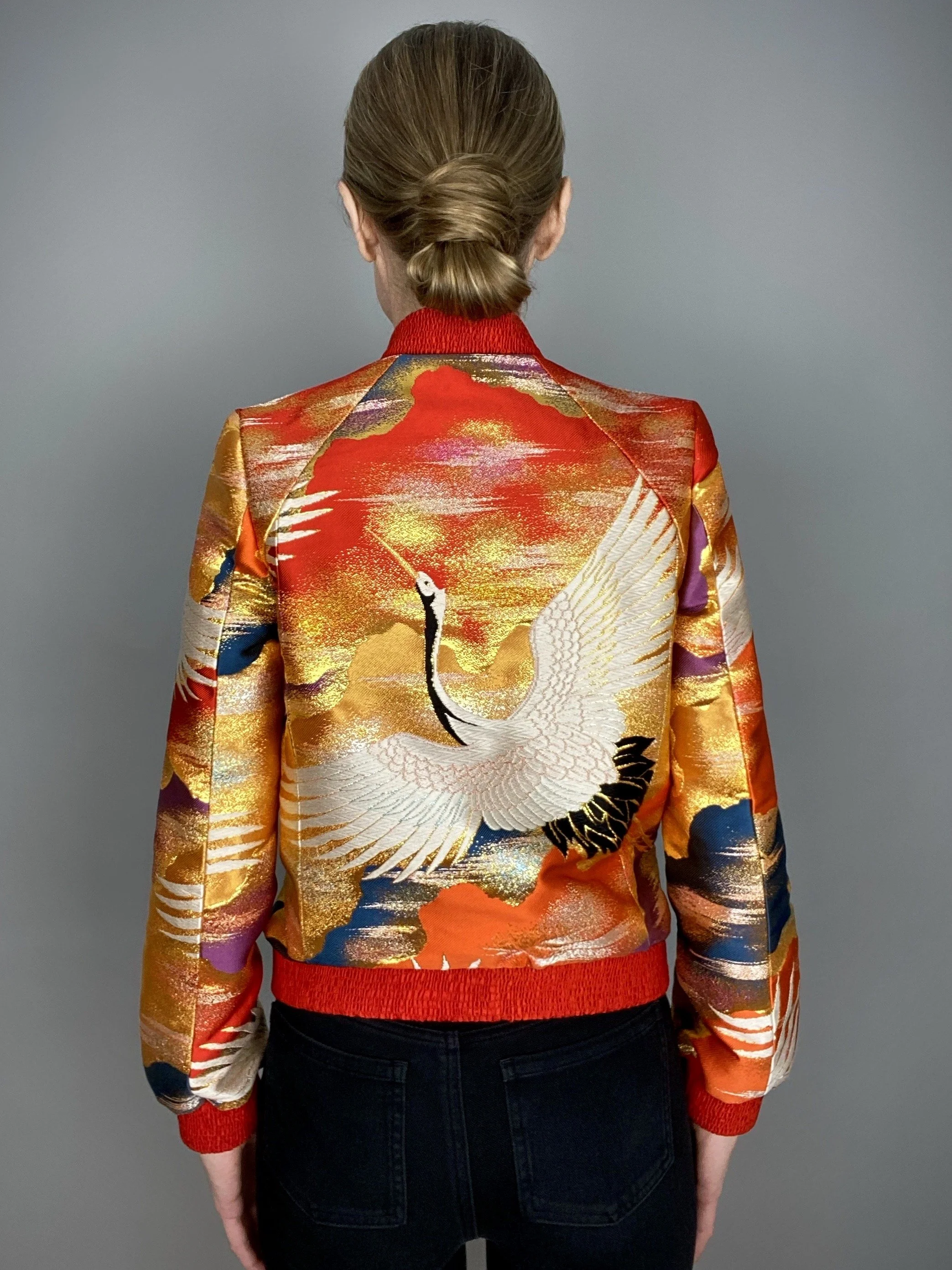 Back view of unique vermillion red bomber jacket crafted from vintage Japanese kimono silk