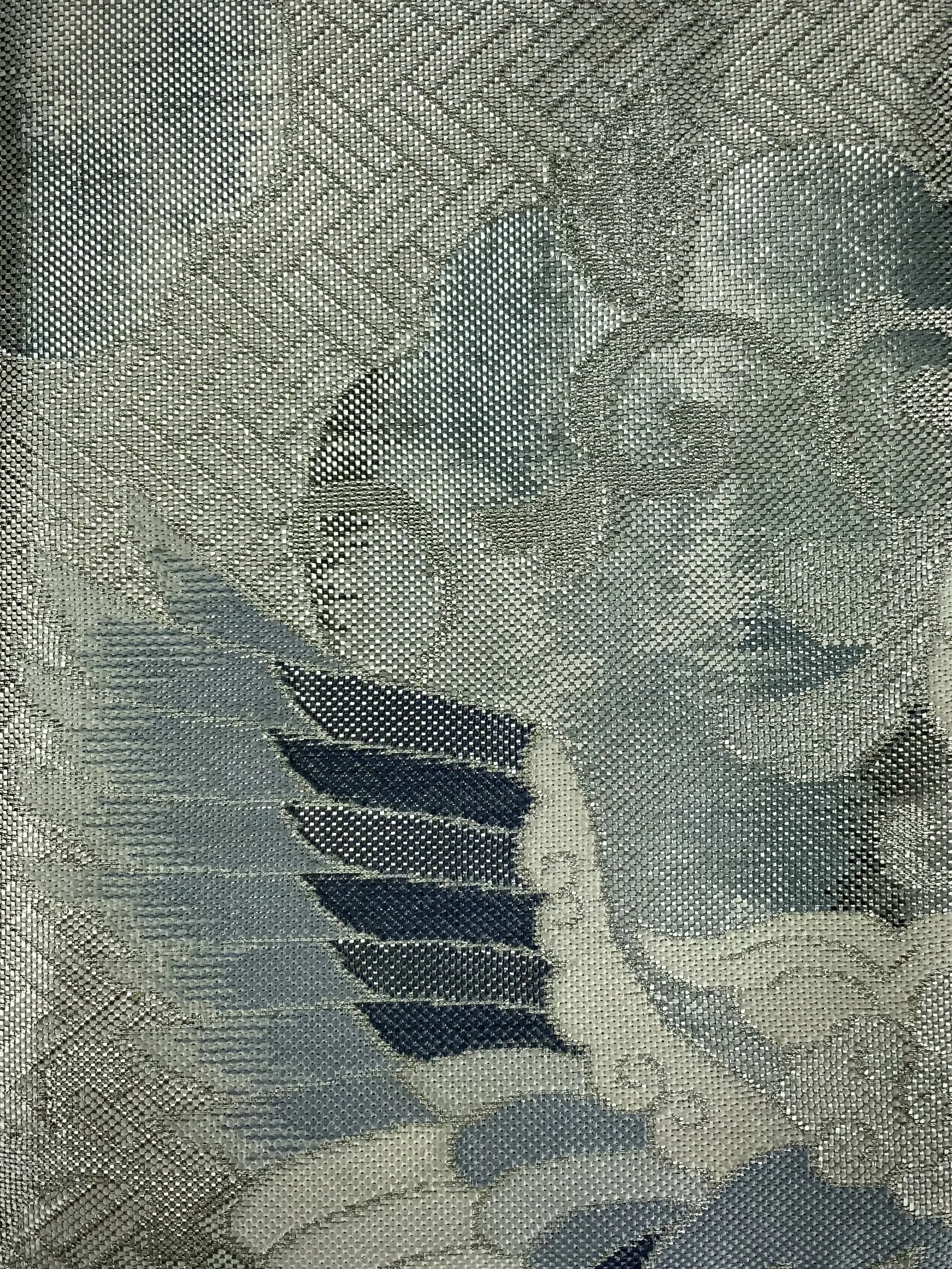 Closeup of silver clutch purse with tassel and moonstone beads, made from vintage Japanese obi silk