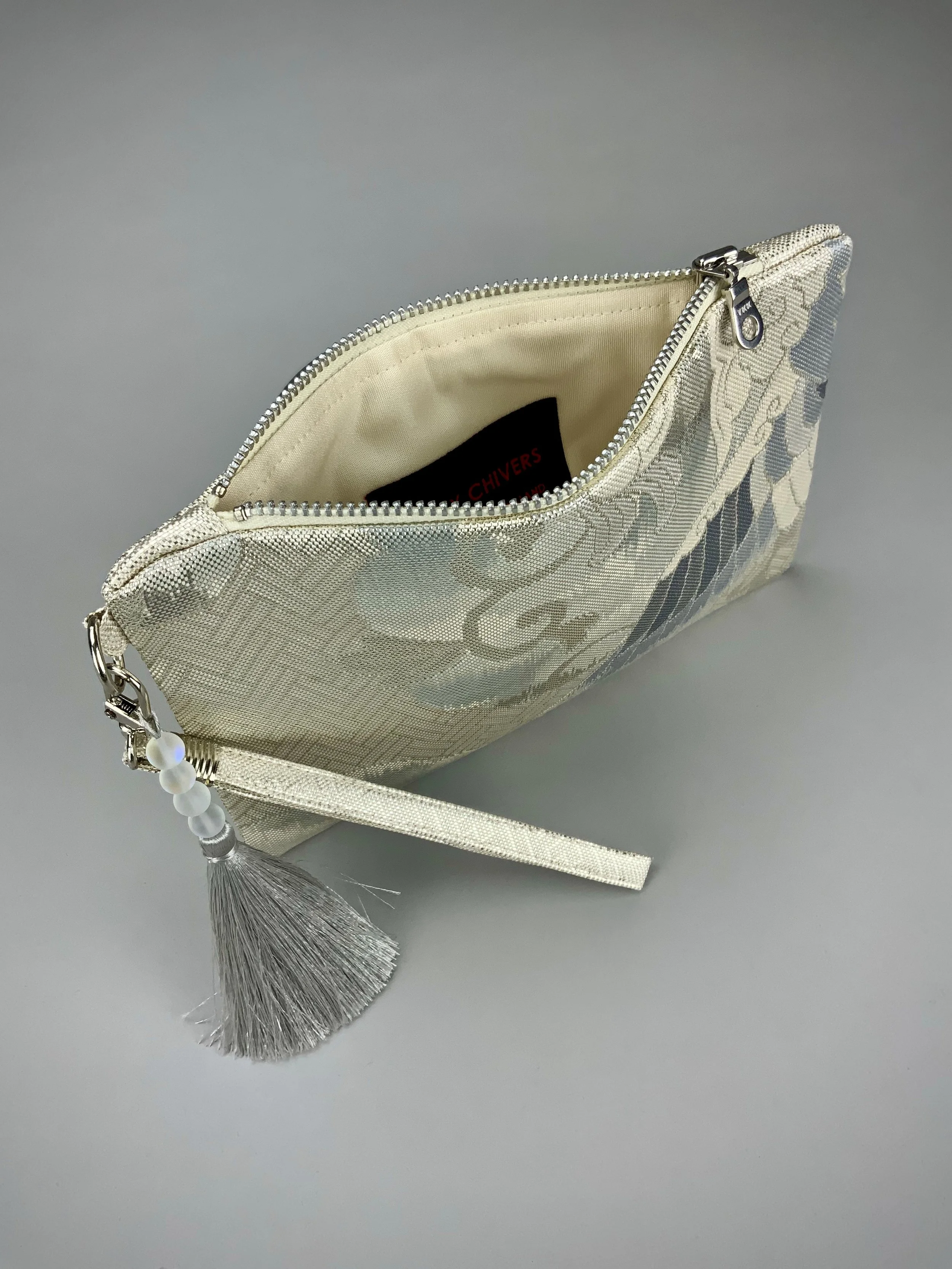 Interior of silver clutch purse with tassel and moonstone beads, made from vintage Japanese obi silk
