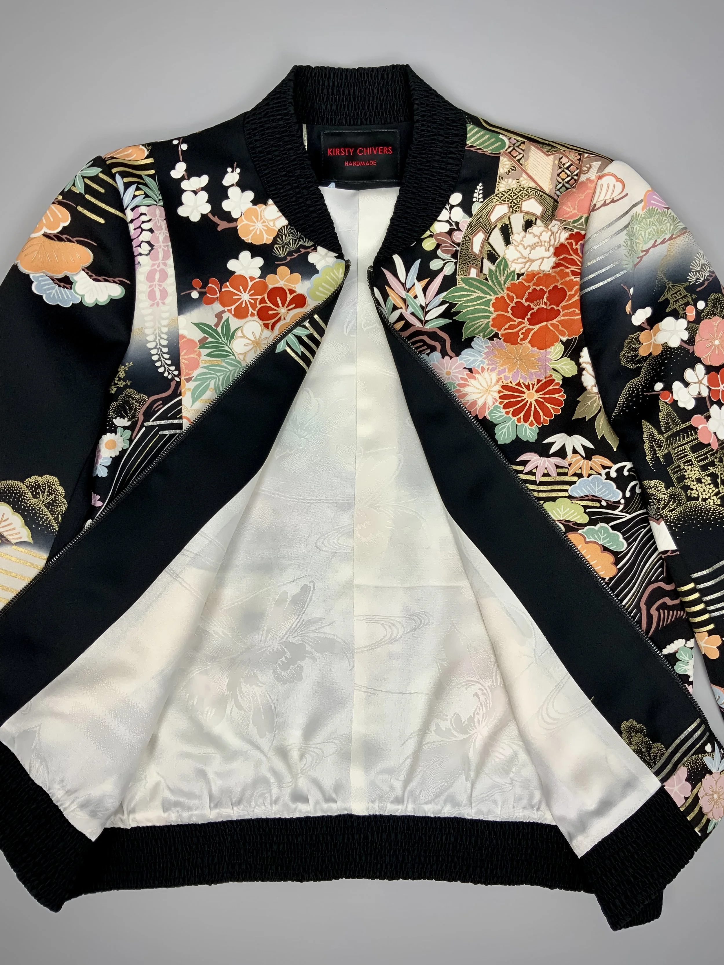 Closeup of unique black printed bomber jacket handmade using vintage Japanese Furisode kimono silk