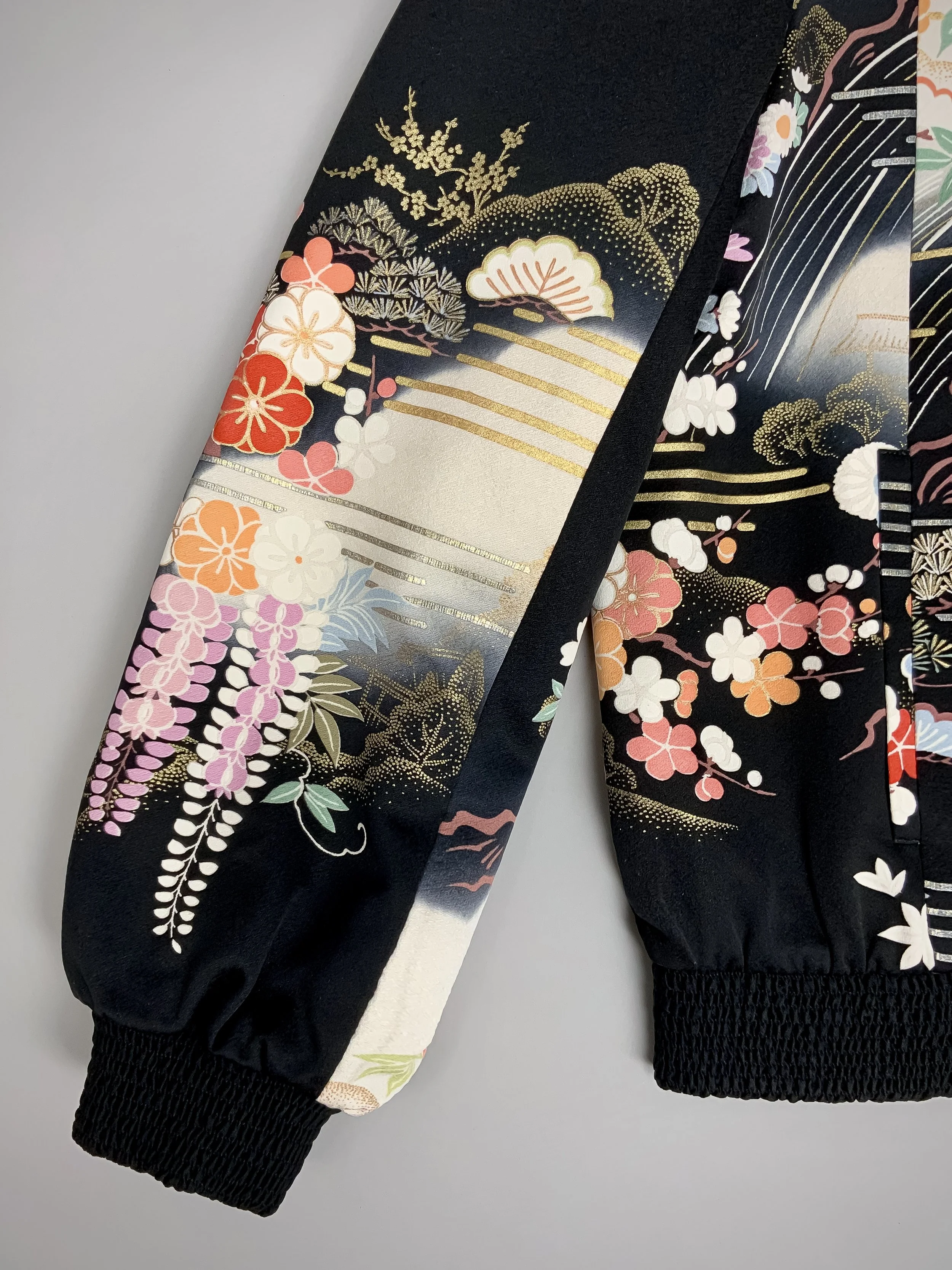 Closeup of unique black printed bomber jacket handmade using vintage Japanese Furisode kimono silk