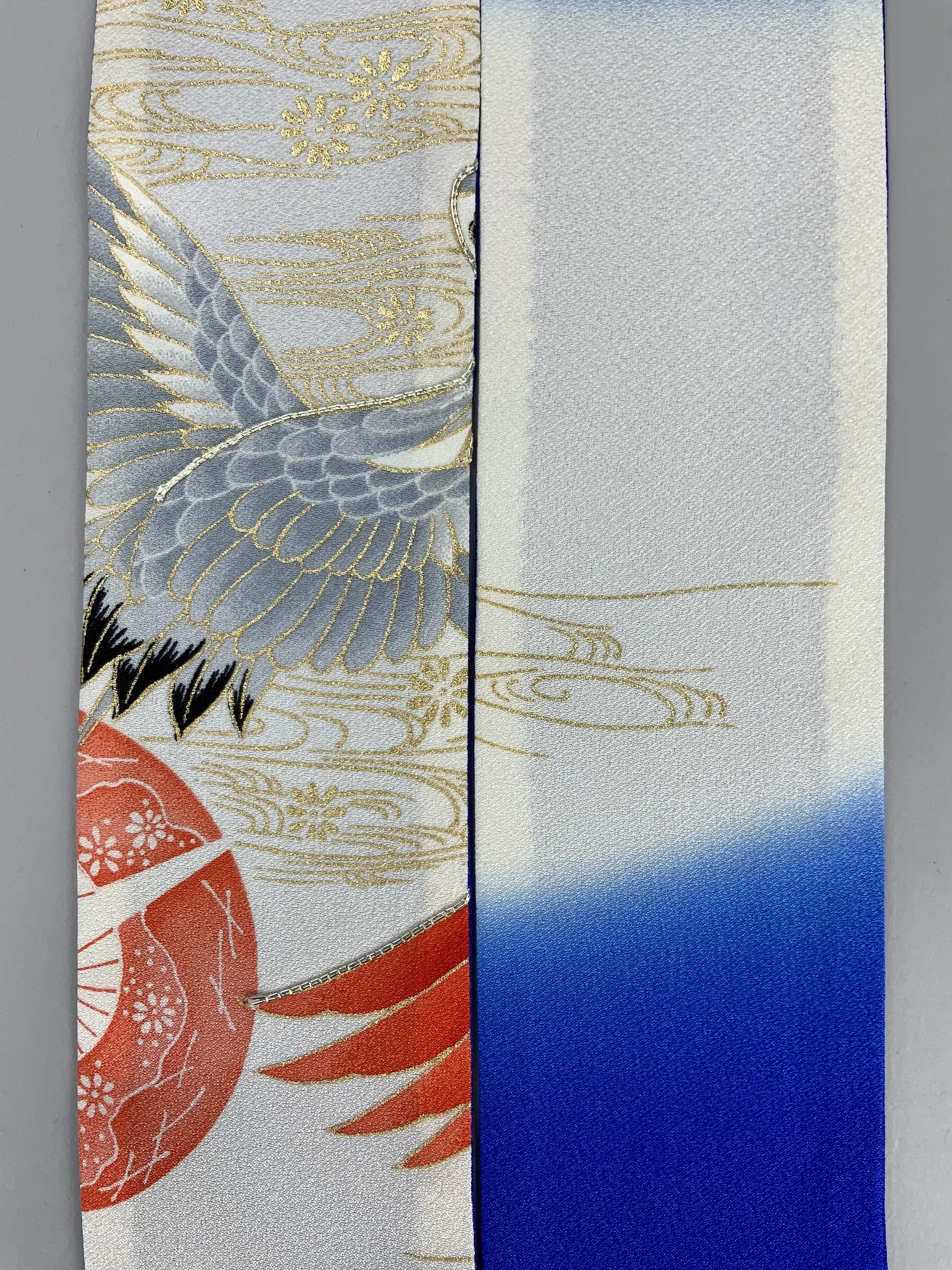 Closeup of blue silk scarf with printed Flying Crane design handmade by Kirsty Chivers