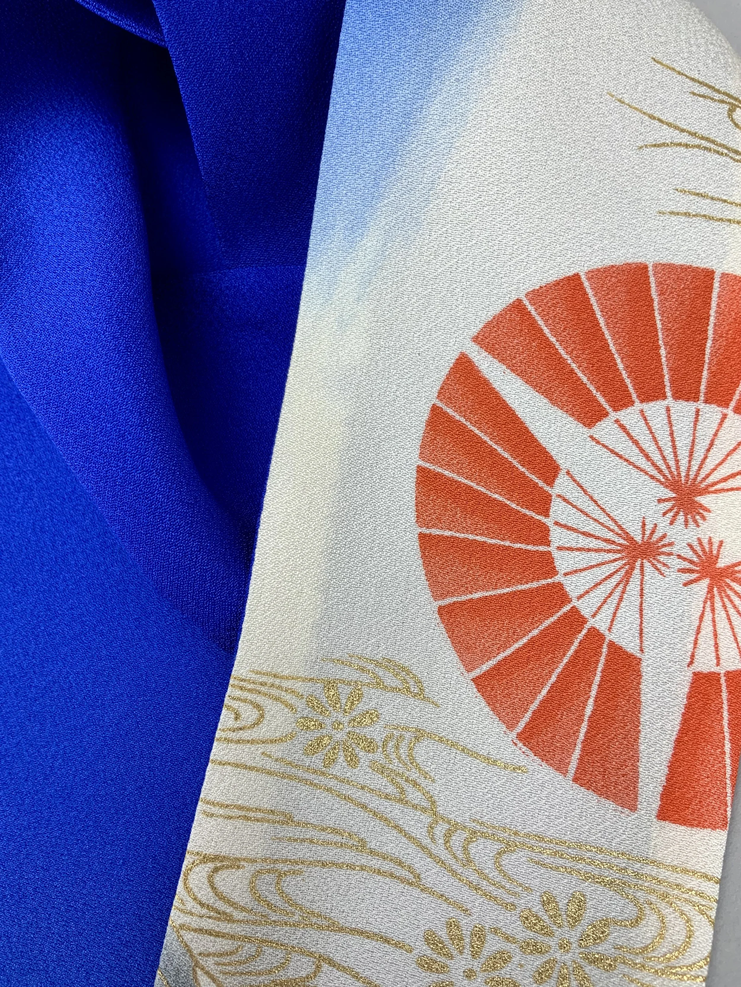 Closeup of blue silk scarf with printed Flying Crane design handmade by Kirsty Chivers