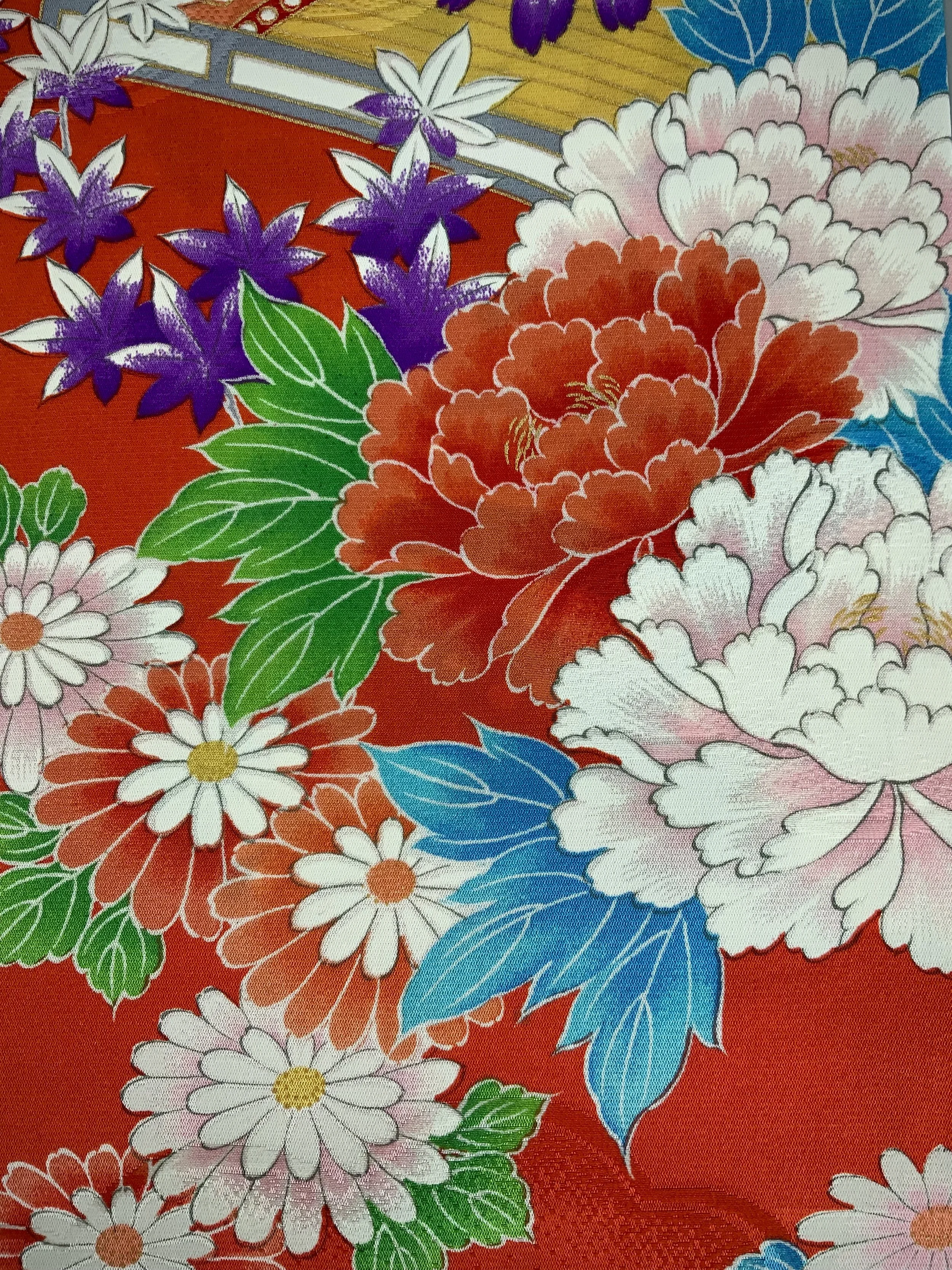 Closeup of orange scarf with blossom print made from rinzu kimono silk by Kirsty Chivers