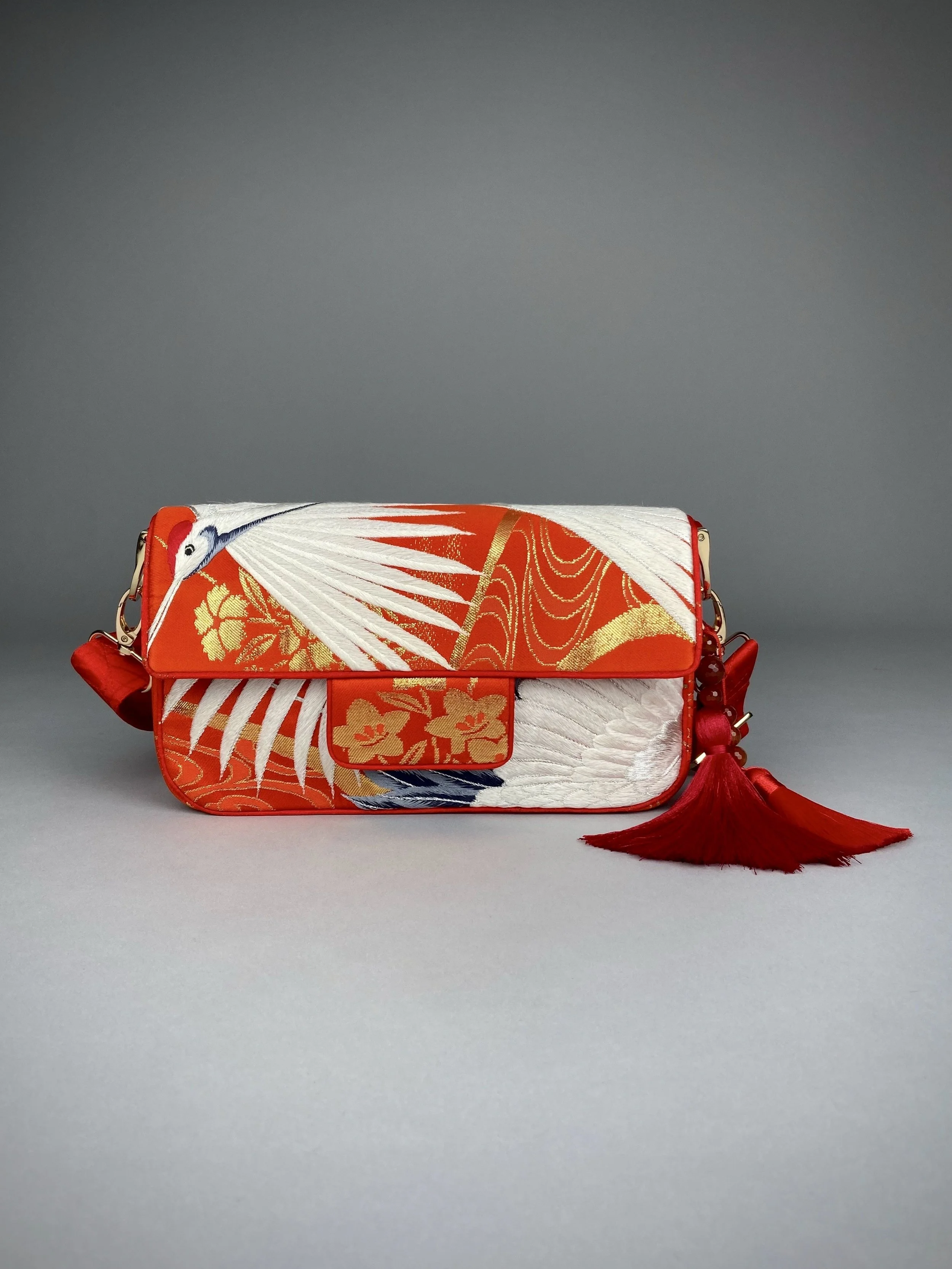 Vermillion Crane Feather baguette bag, made from vintage Japanese kimono silk, with gold hardware and Agate beaded tassel charms by Kirsty Chivers