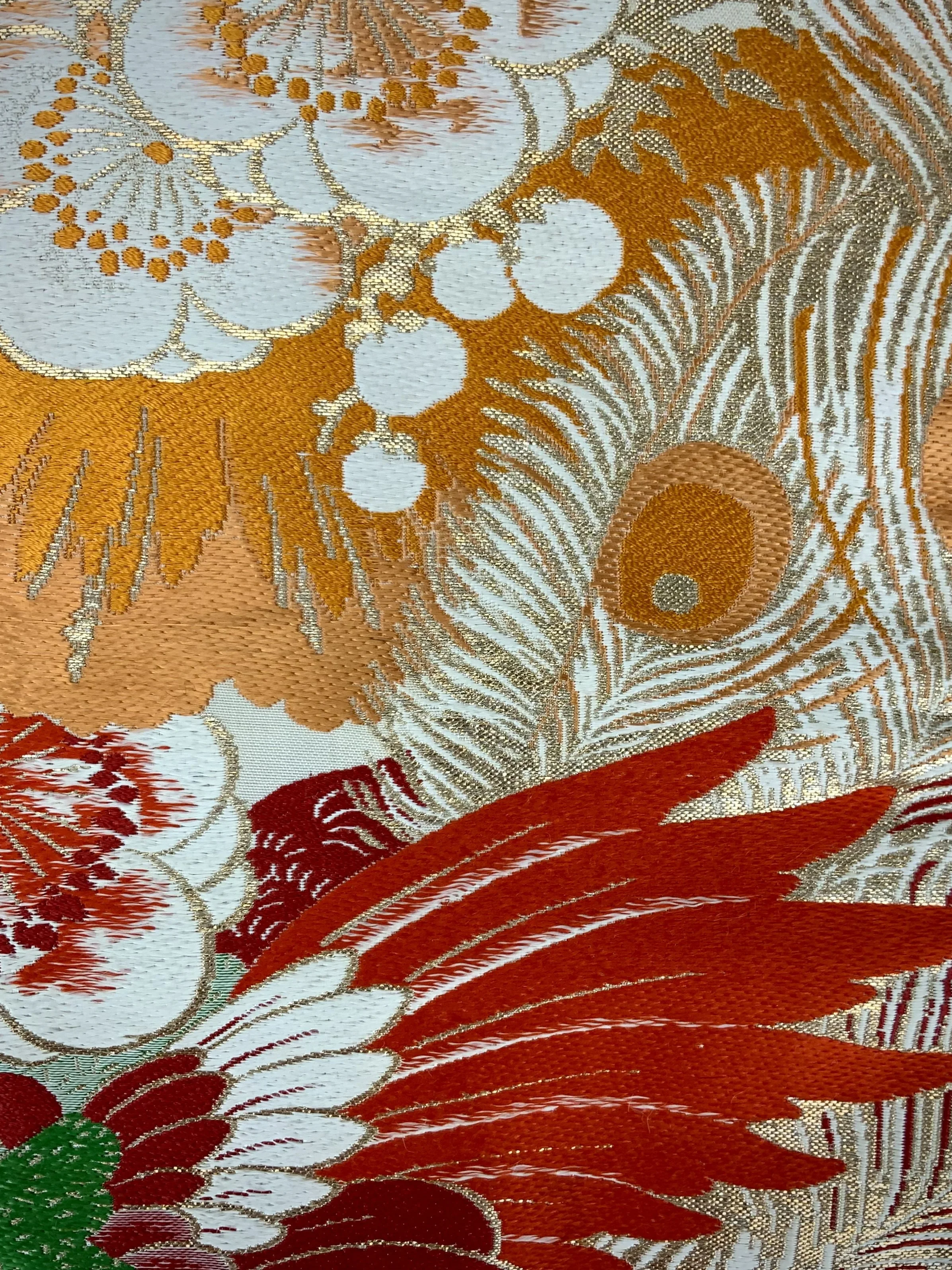 Closeup of unique evening bag in vintage obi silk with peacock, pine motifs & gold accents by Kirsty Chivers