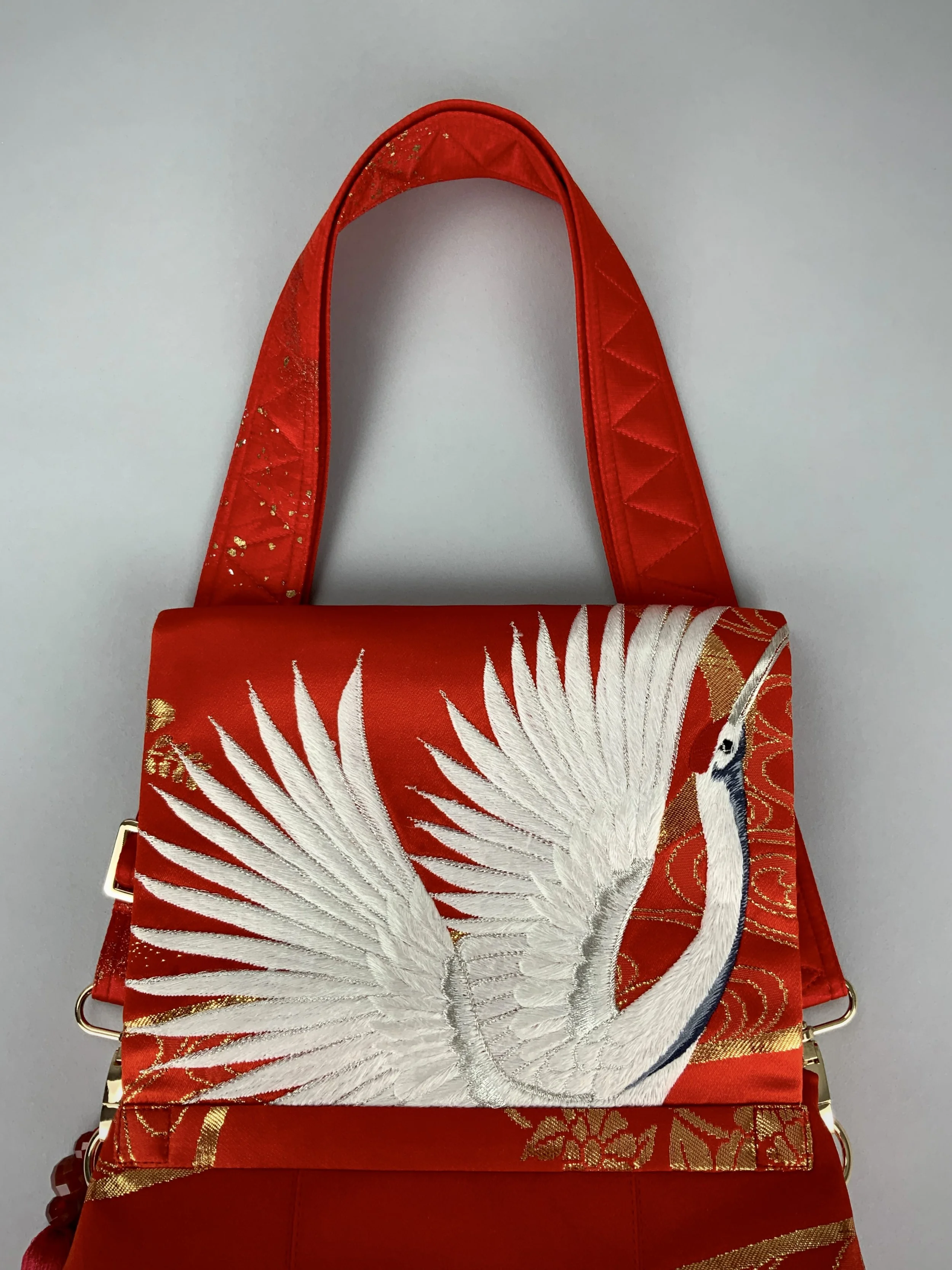 Vermillion red evening bag with embroidered crane design, handmade from vintage kimono silk by Kirsty Chivers
