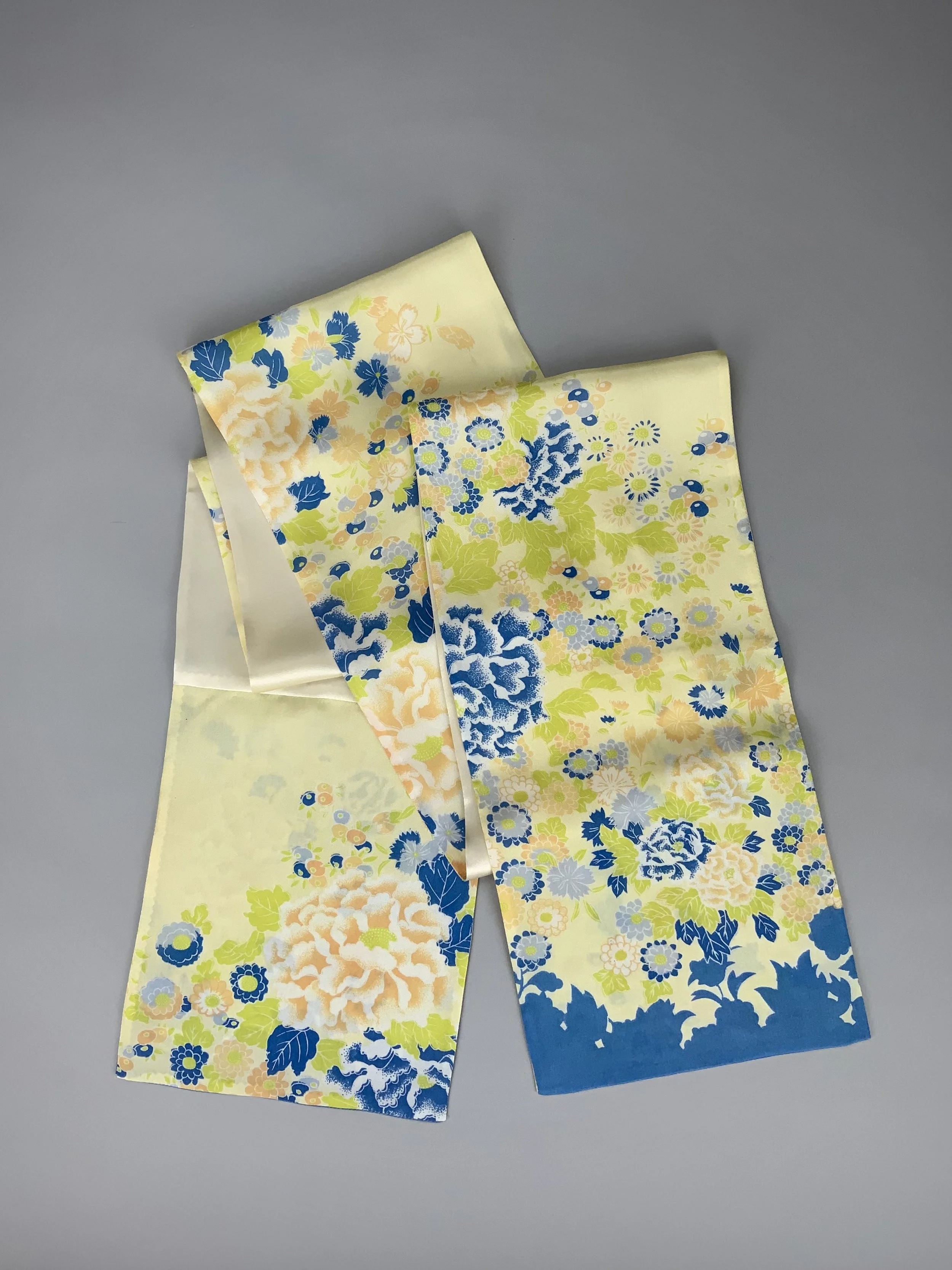 Flatlay of yellow scarf with blossom print handmade from kimono fabric and silk satin by Kirsty Chivers