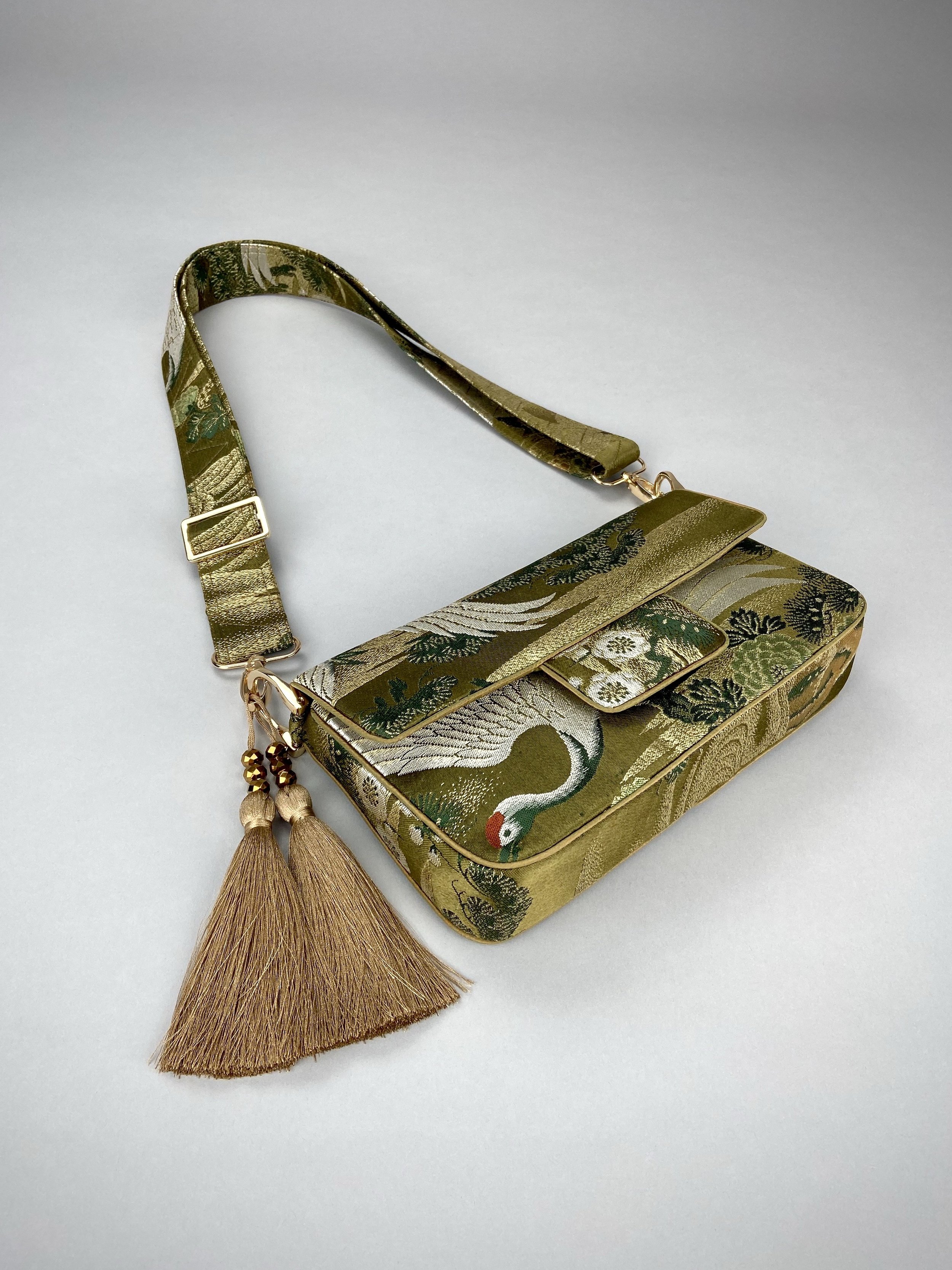 Unique Flying Crane baguette bag, handmade from vintage Japanese obi silk with gold hardware and matching silk tassel charm by Kirsty Chivers