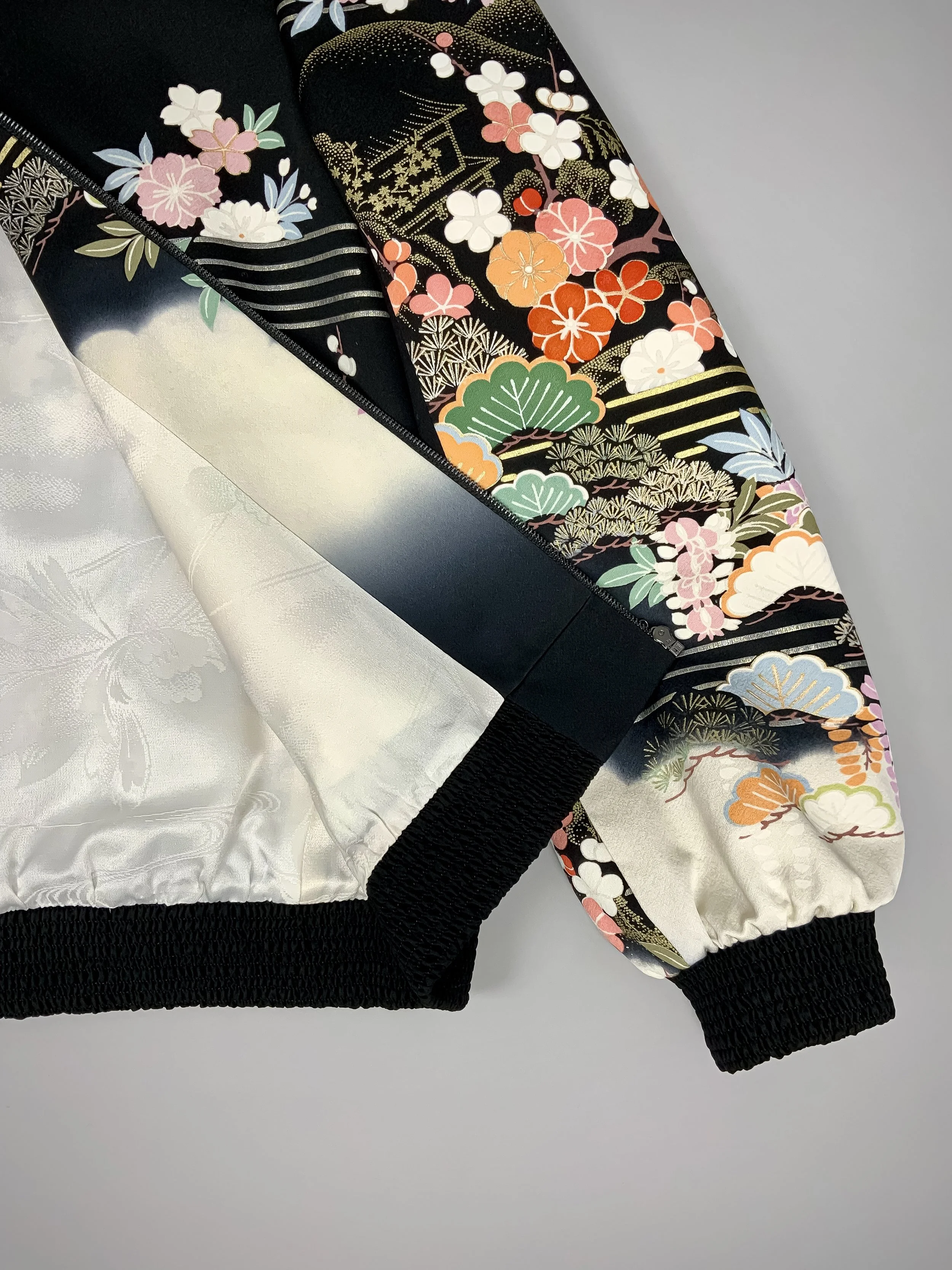 Closeup of unique bomber jacket with printed design, handmade with vintage Japanese Furisode kimono silk