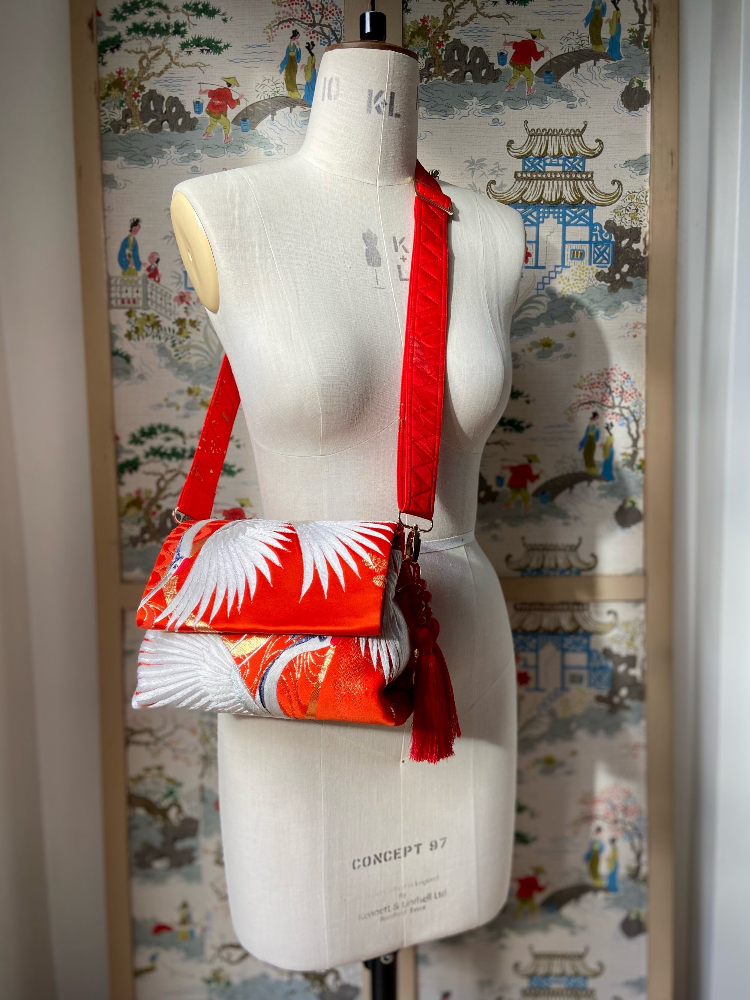 Vermillion red evening bag with embroidered crane design, handmade from vintage kimono silk by Kirsty Chivers