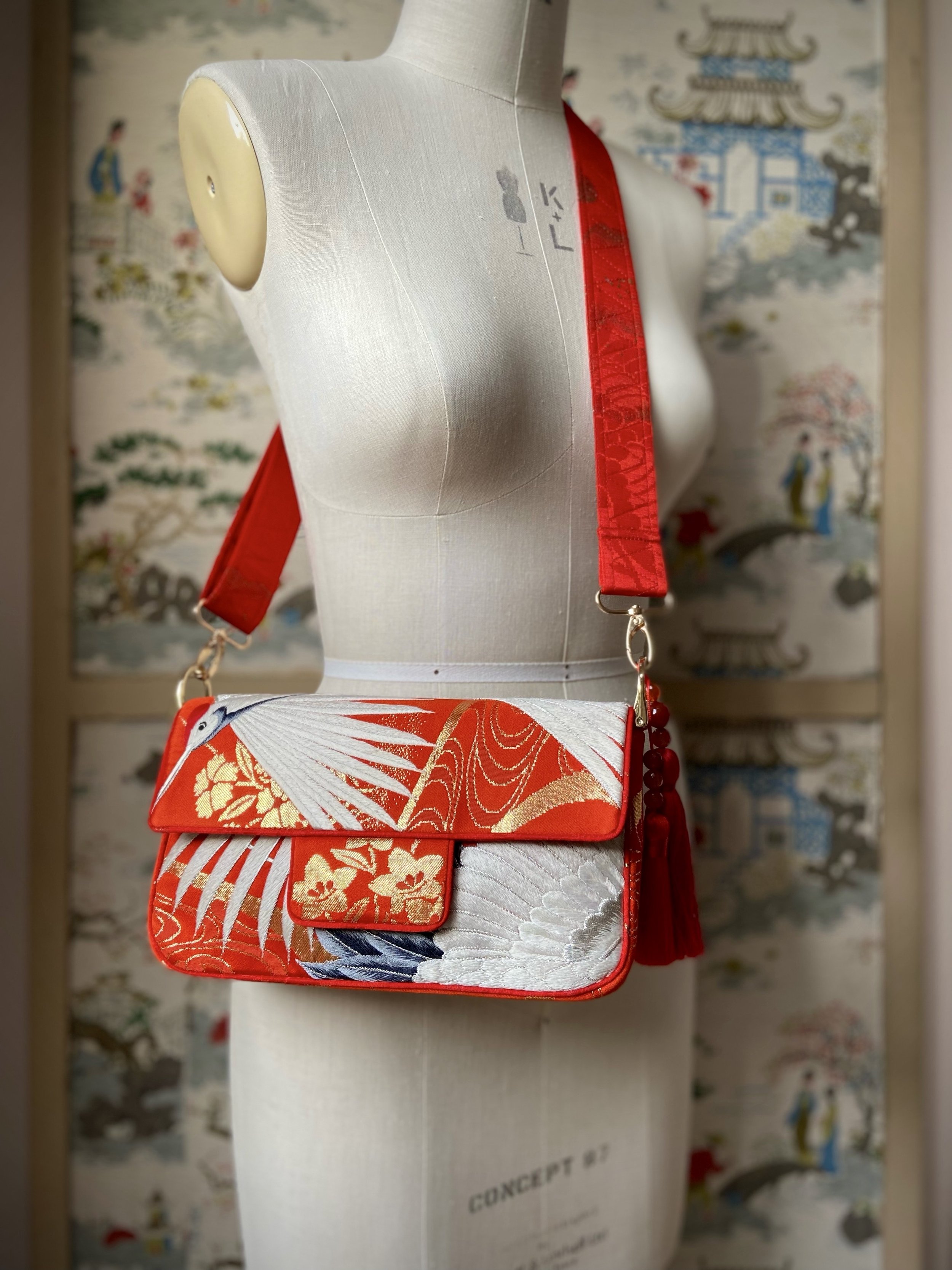 Vermillion Crane Feather baguette bag, made from vintage Japanese kimono silk, with gold hardware and Agate beaded tassel charms by Kirsty Chivers