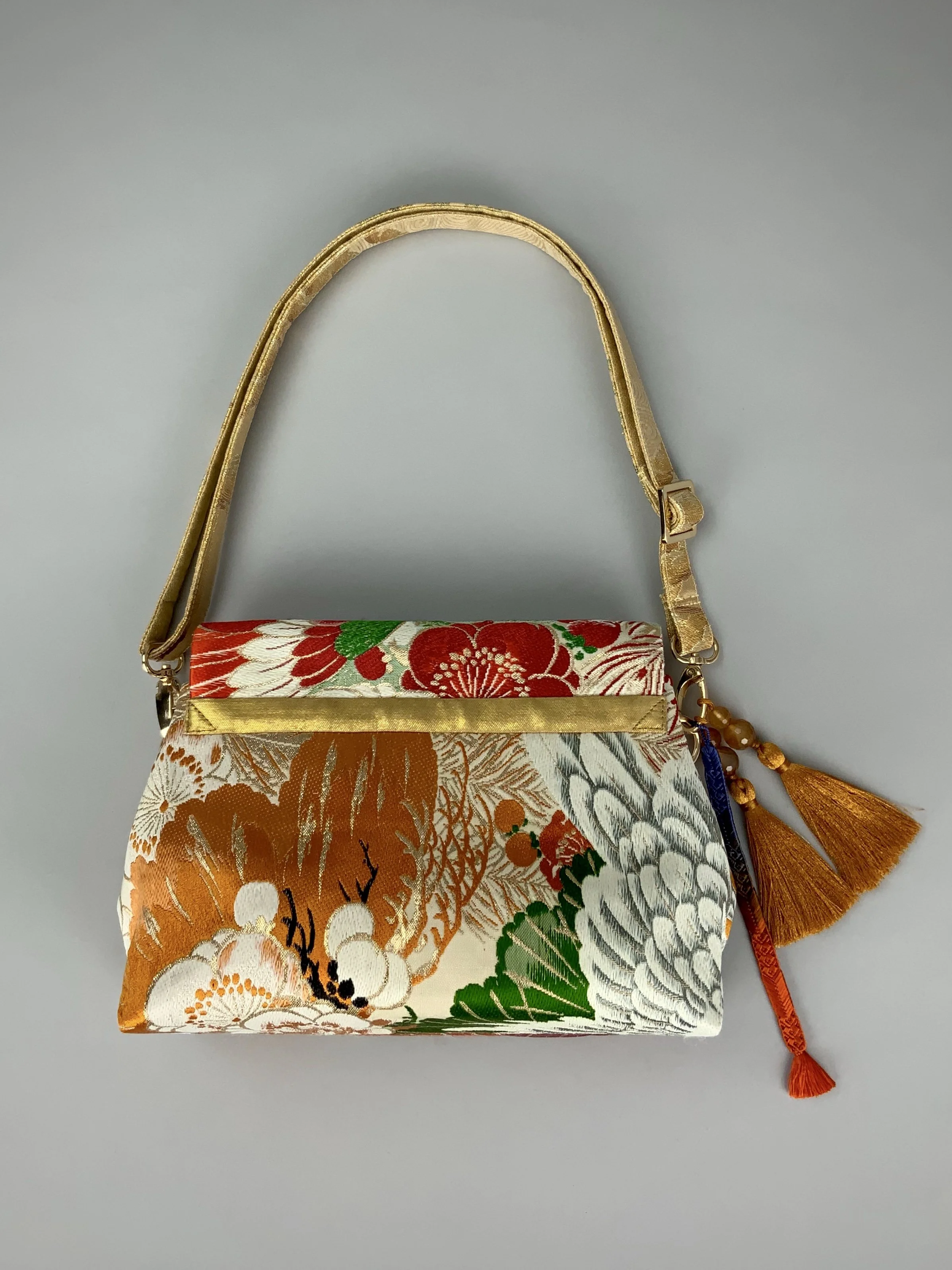 One-of-a-kind evening bag in vintage obi silk with peacock, pine motifs & gold accents