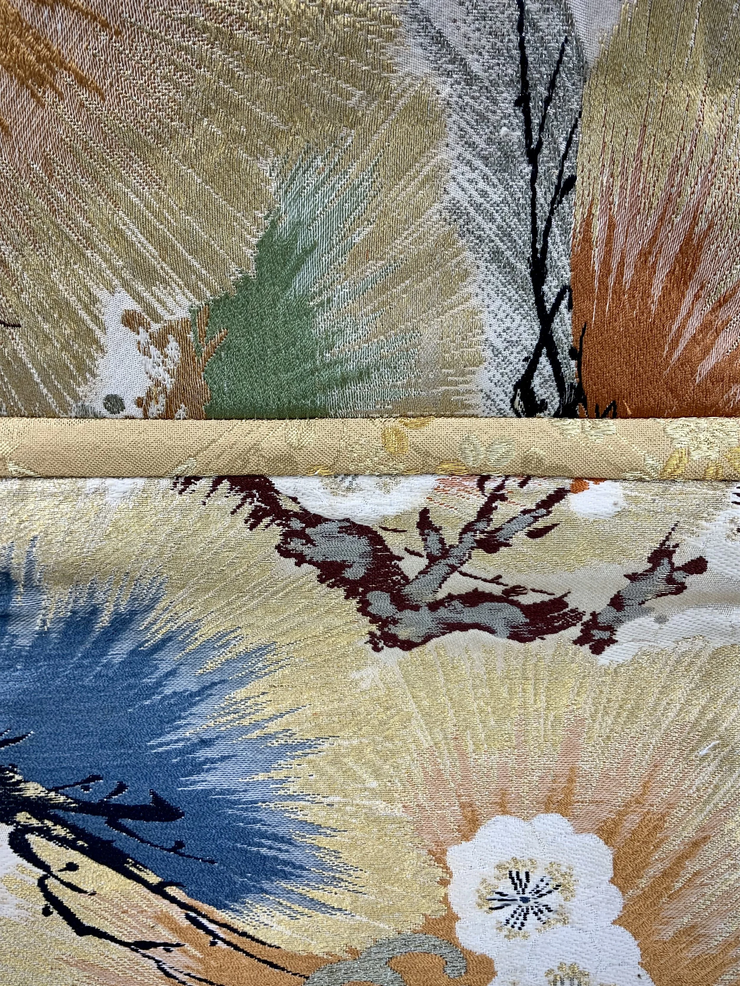 Closeup of metallic gold evening bag with Matsu pine and blossom design, made from vintage obi silk by Kirsty Chivers