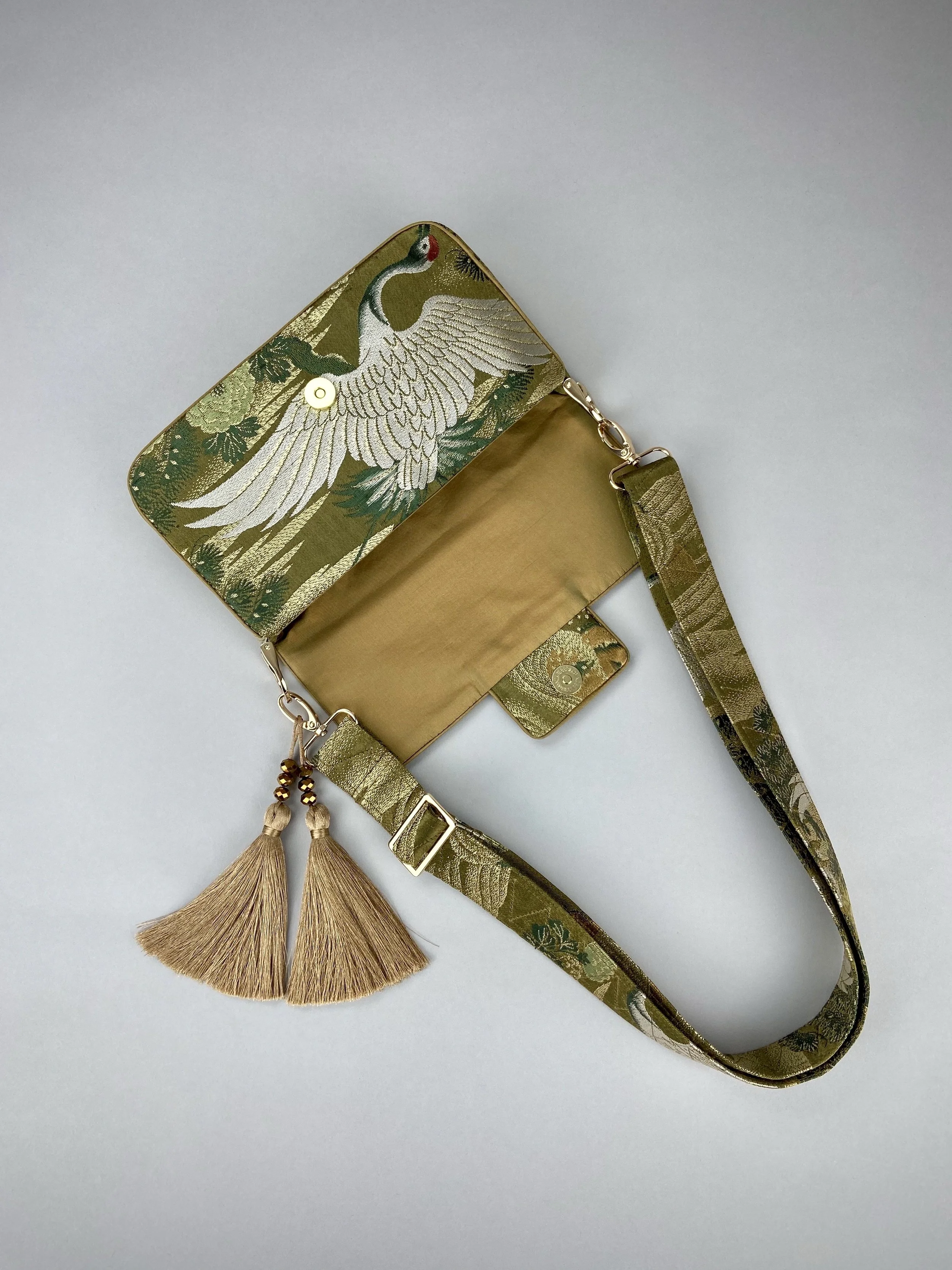 Unique Flying Crane baguette bag, handmade from vintage Japanese obi silk with gold hardware and matching silk tassel charm by Kirsty Chivers