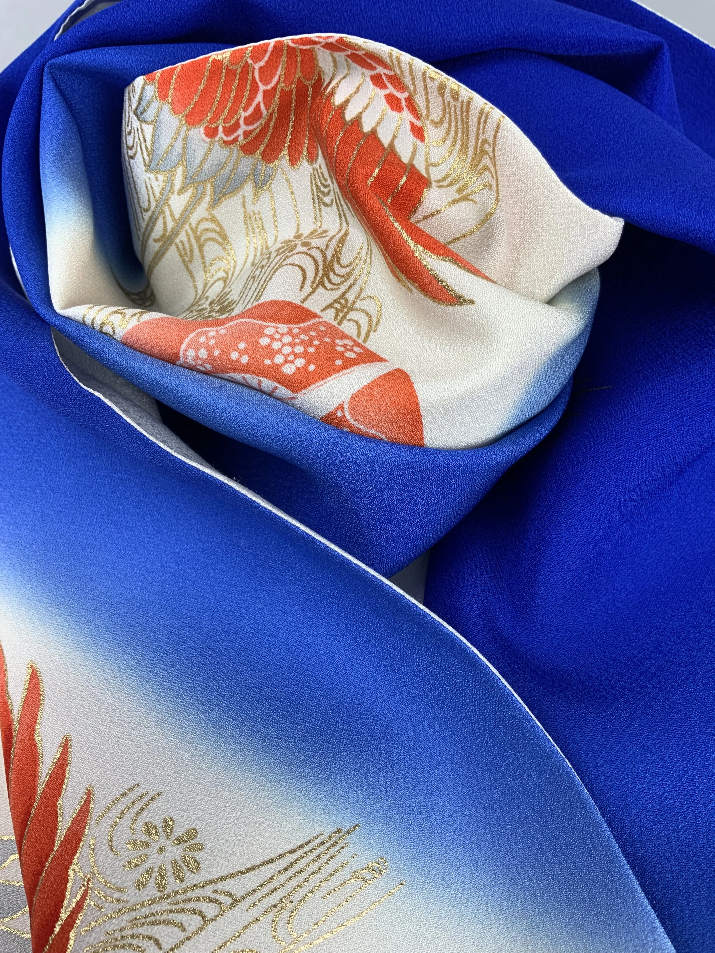 Closeup of electric blue silk scarf with Flying Crane print handmade by Kirsty Chivers