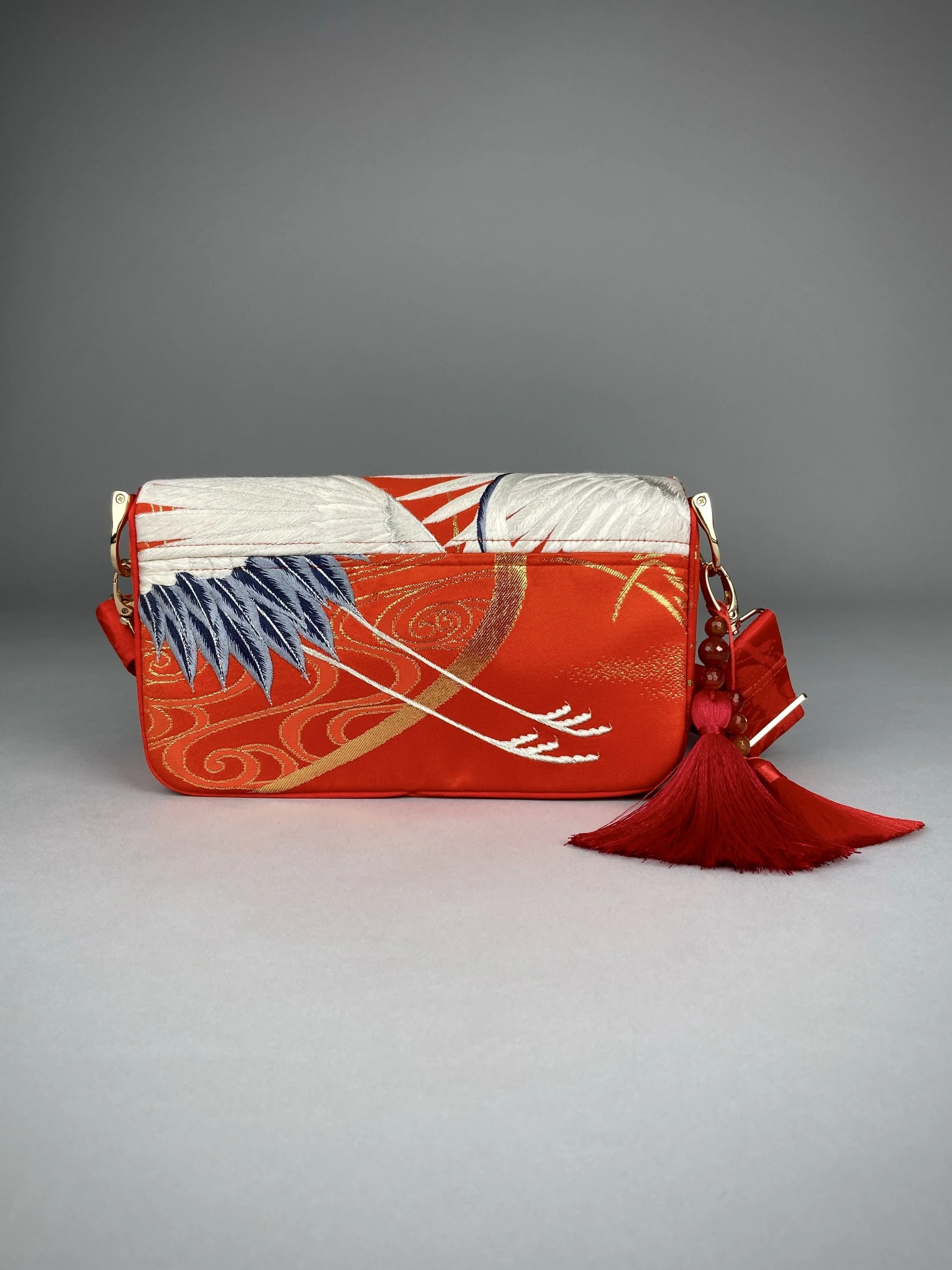 Vermillion Crane Feather baguette bag, made from vintage Japanese kimono silk, with gold hardware and Agate beaded tassel charms by Kirsty Chivers