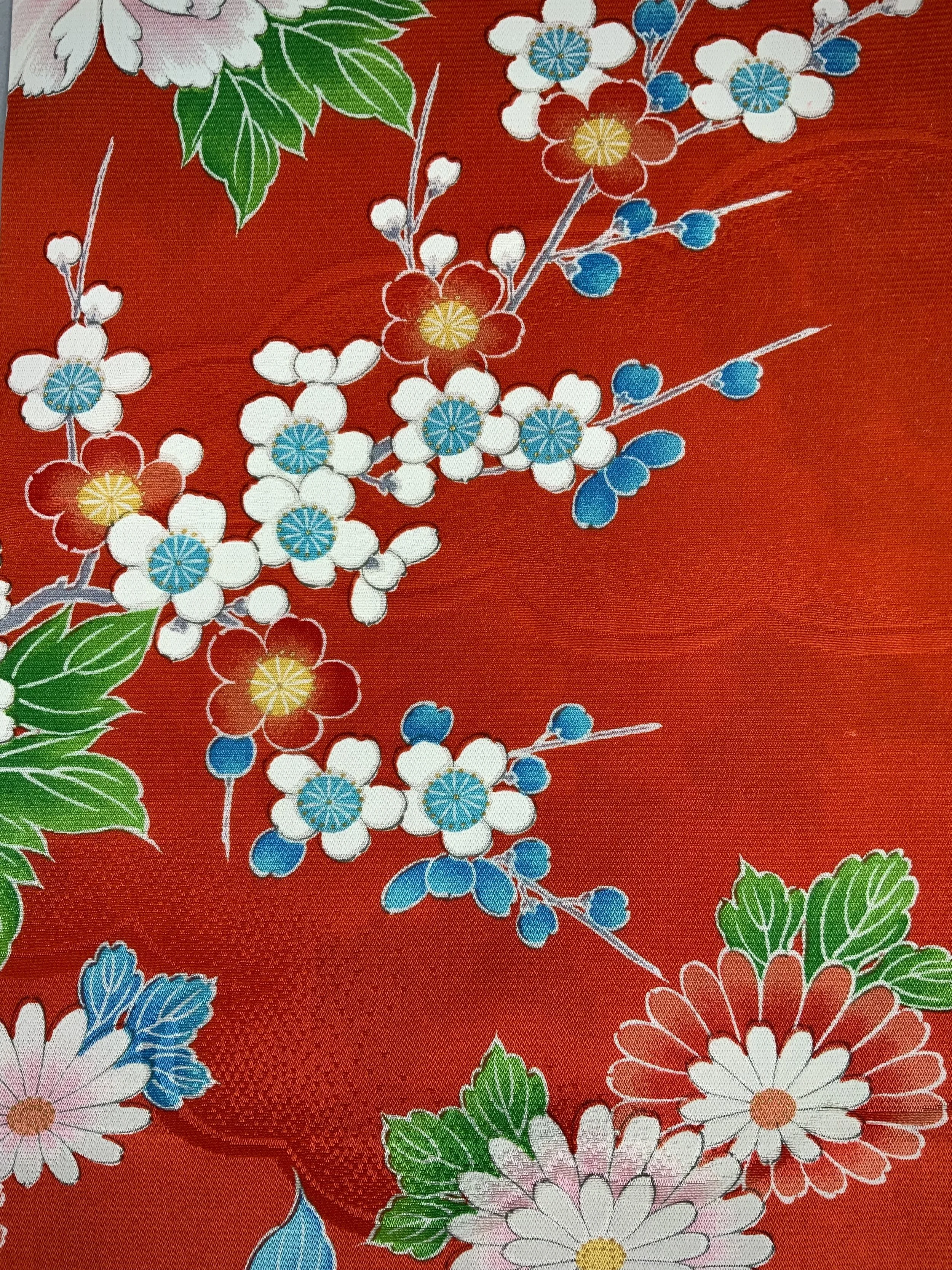 Closeup of orange scarf with blossom print made from rinzu kimono silk by Kirsty Chivers