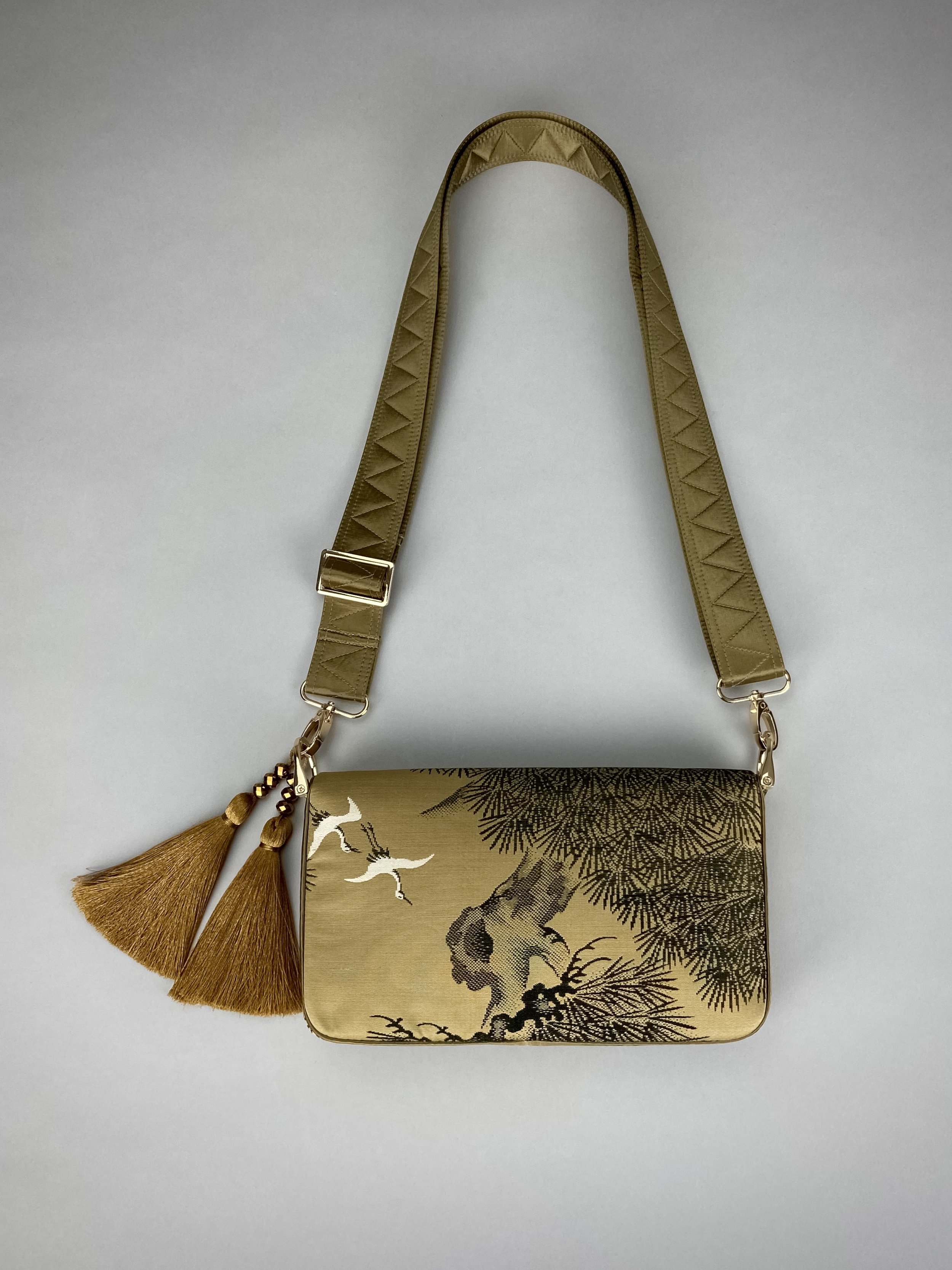 Unique Matsu pine baguette bag, made from vintage Japanese obi silk, with crane design, gold hardware and matching tassel charms by Kirsty Chivers