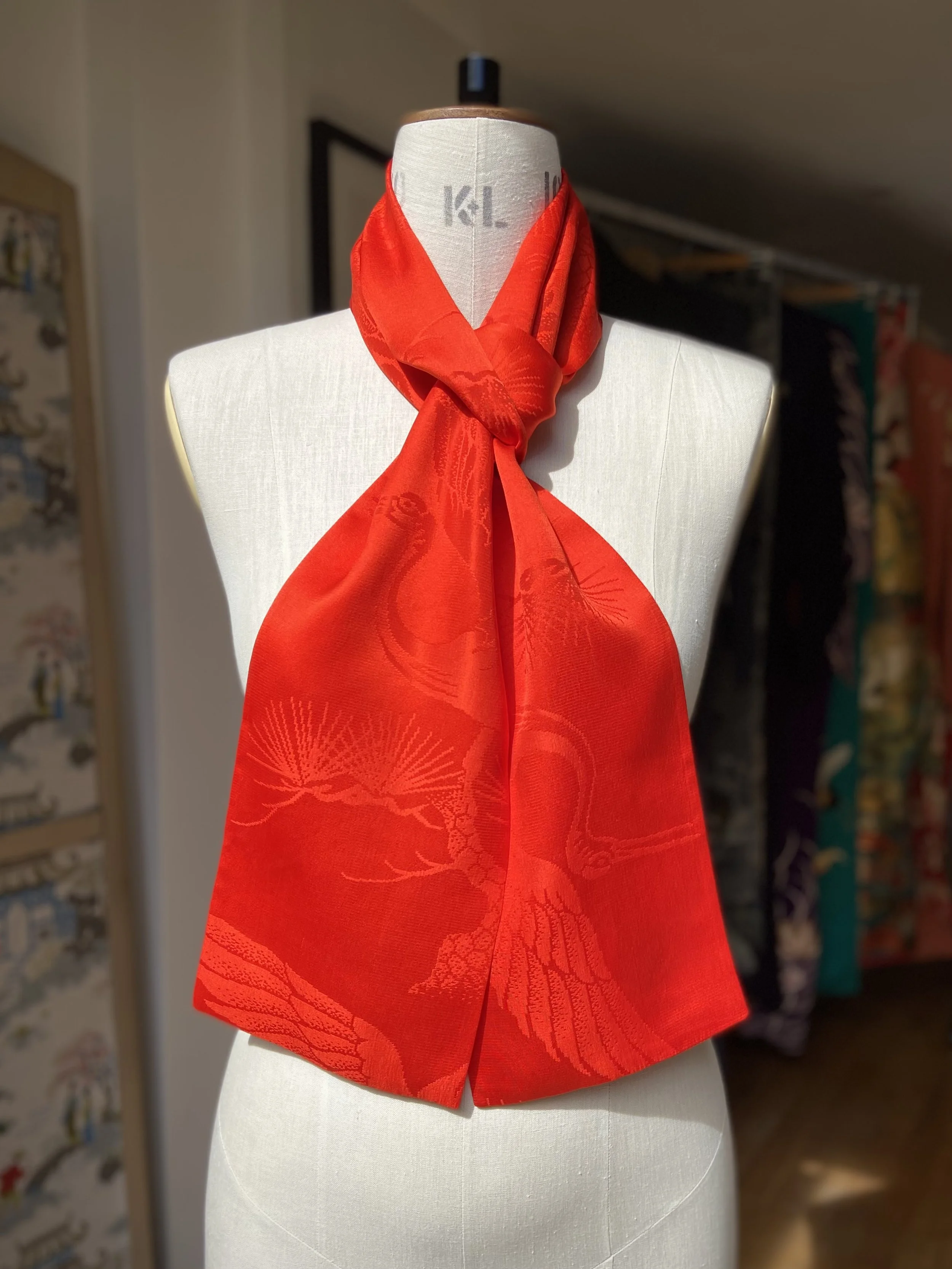Vibrant vermillion red silk scarf crafted from kimono silk by Kirsty Chivers Handmade, displayed on a dress stand