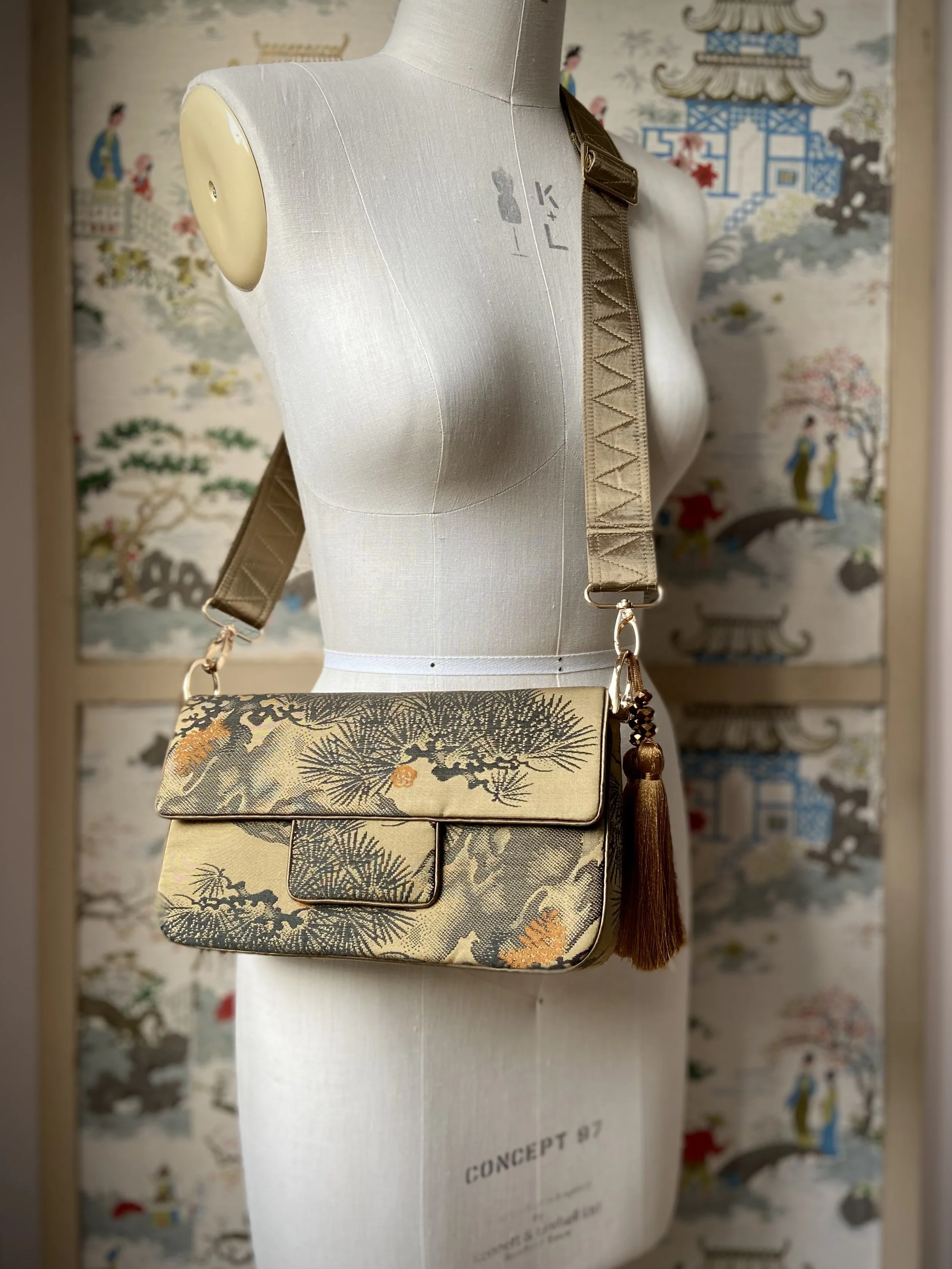 Unique Matsu pine baguette bag, made from vintage Japanese obi silk, with crane design, gold hardware and matching tassel charms by Kirsty Chivers