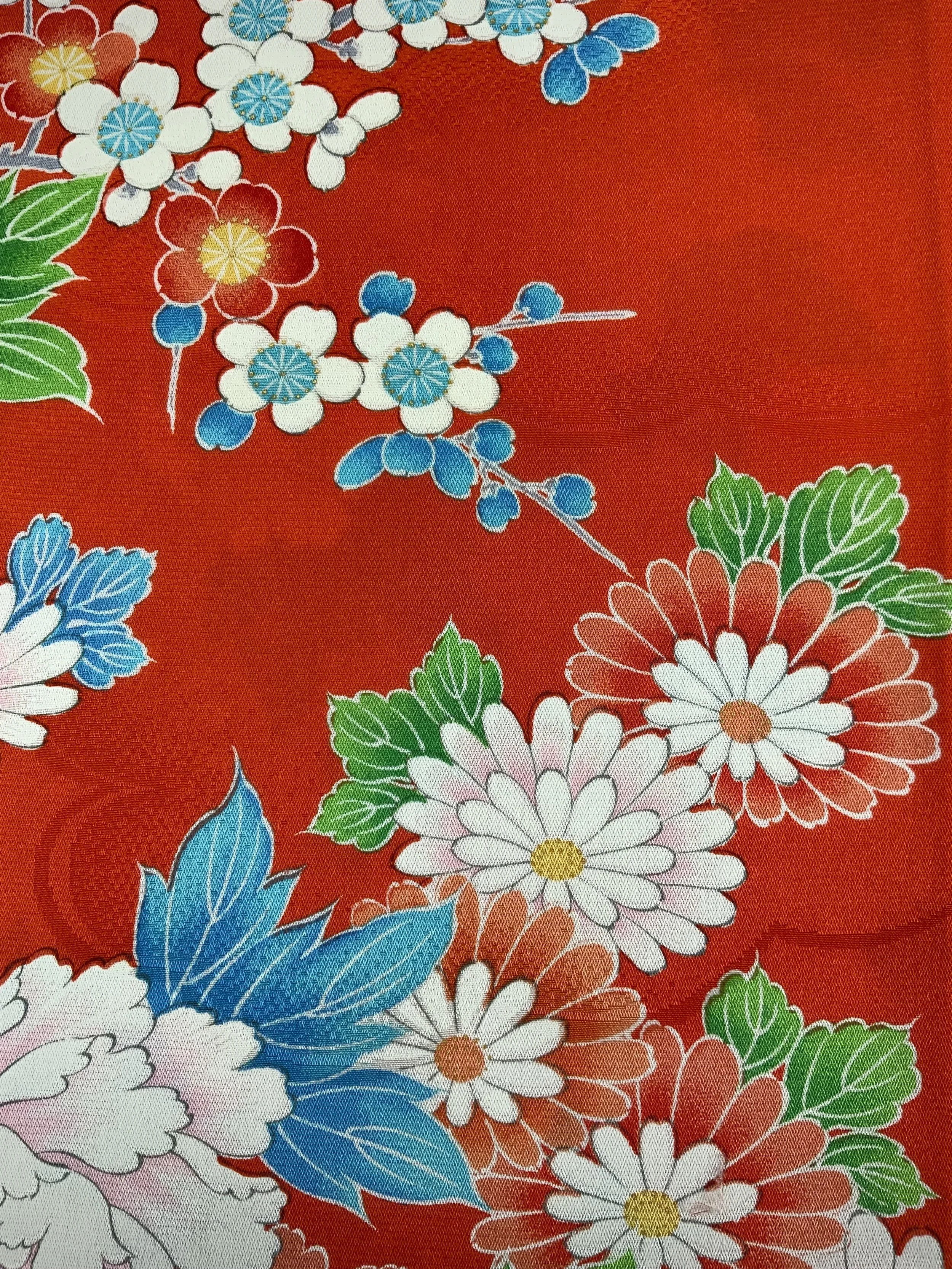 Closeup of orange scarf with blossom print made from rinzu kimono silk by Kirsty Chivers