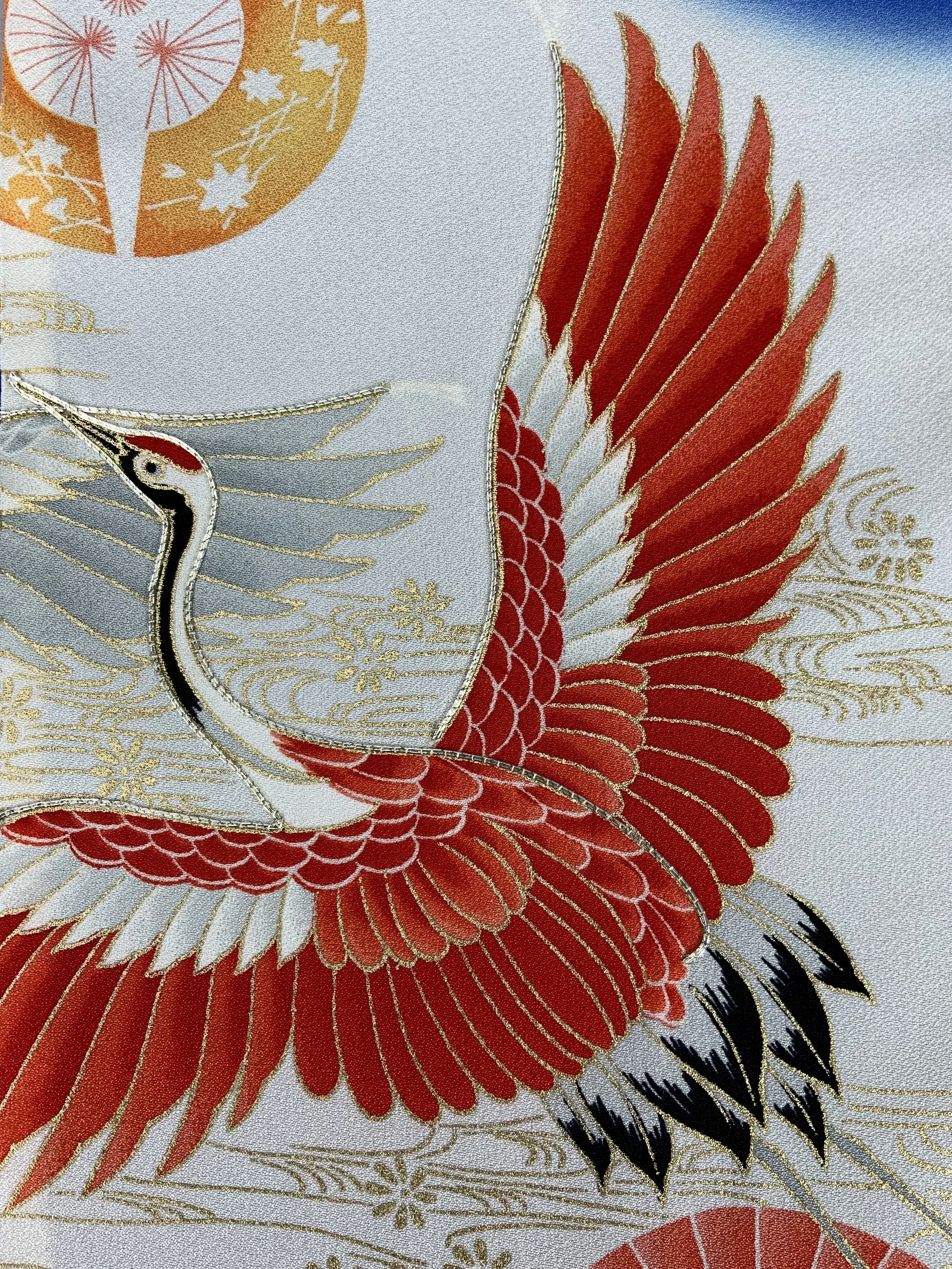 Closeup of blue silk scarf with printed Flying Crane design handmade by Kirsty Chivers