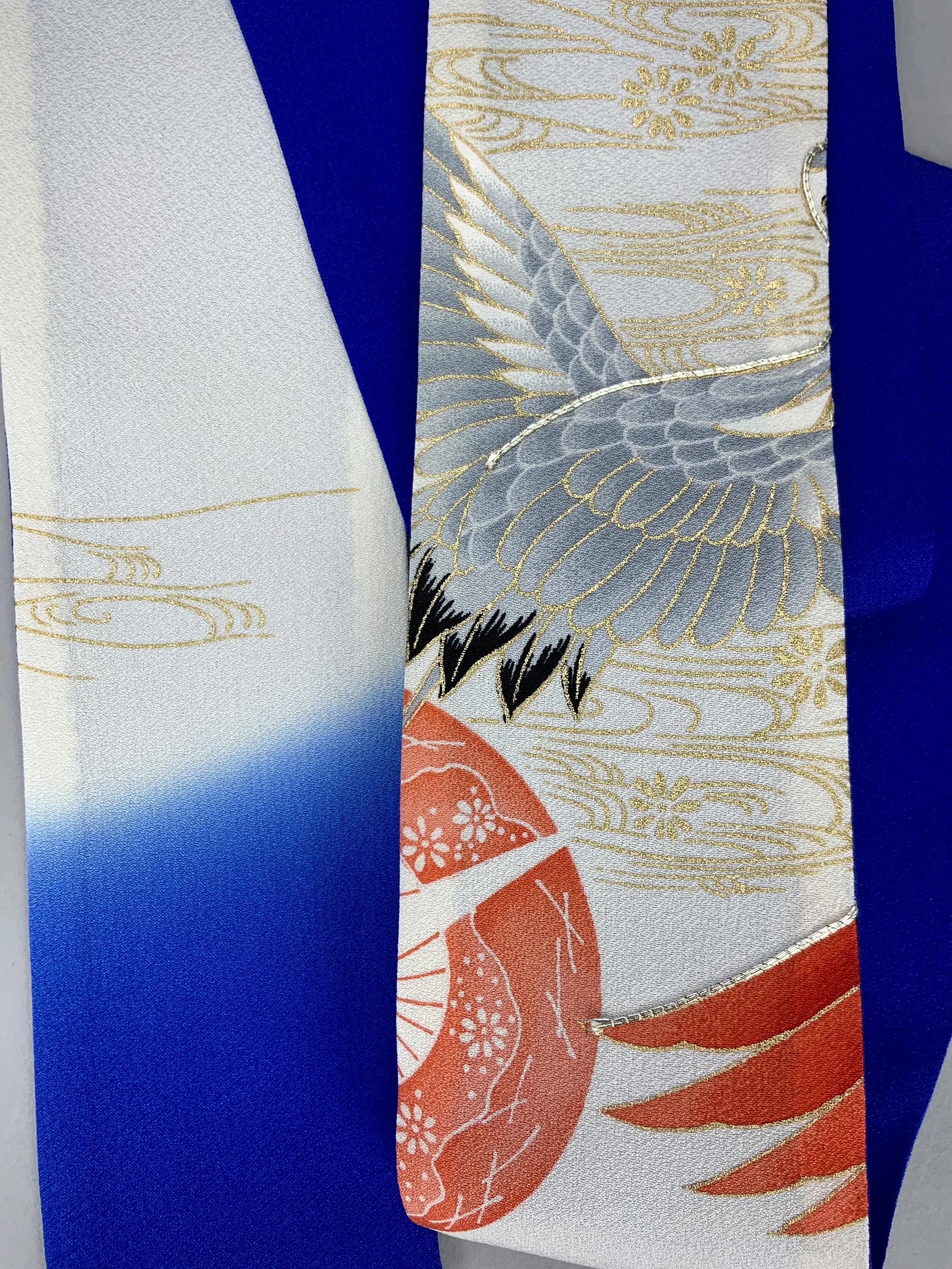 Closeup of blue silk scarf with printed Flying Crane design handmade by Kirsty Chivers