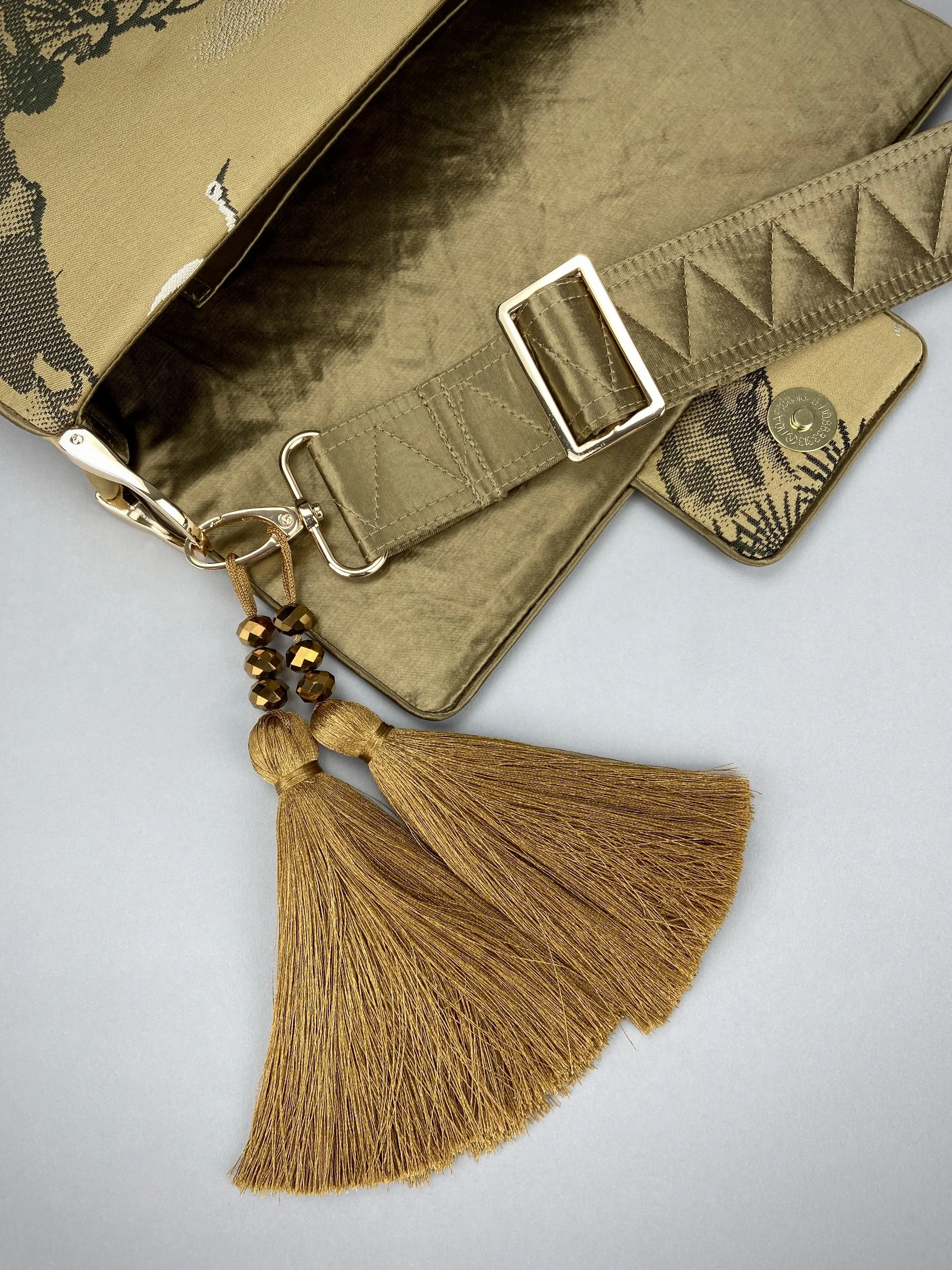 Unique Matsu pine baguette bag, made from vintage Japanese obi silk, with crane design, gold hardware and matching tassel charms by Kirsty Chivers