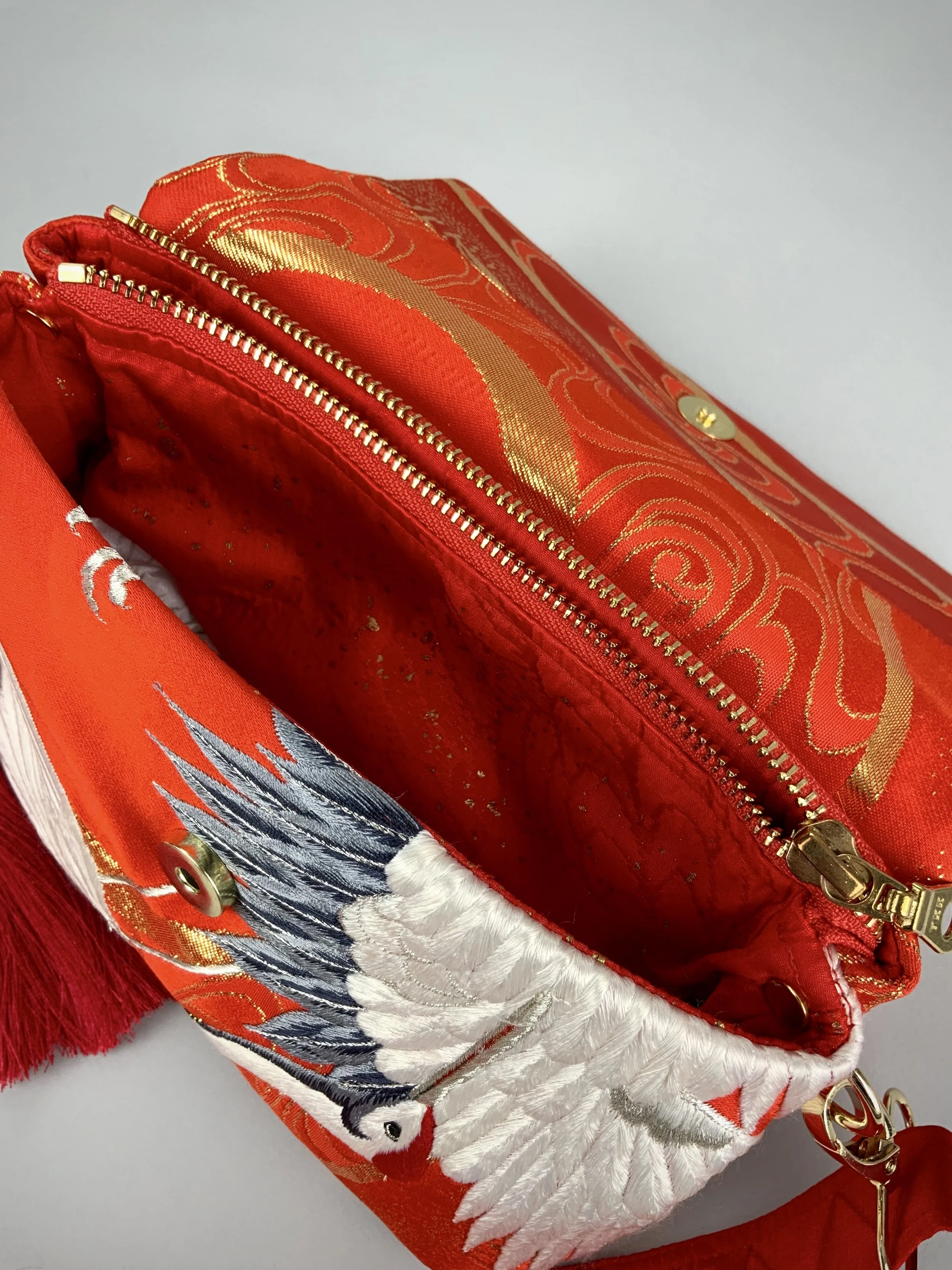 Vermillion red evening bag with embroidered crane design, handmade from vintage kimono silk by Kirsty Chivers