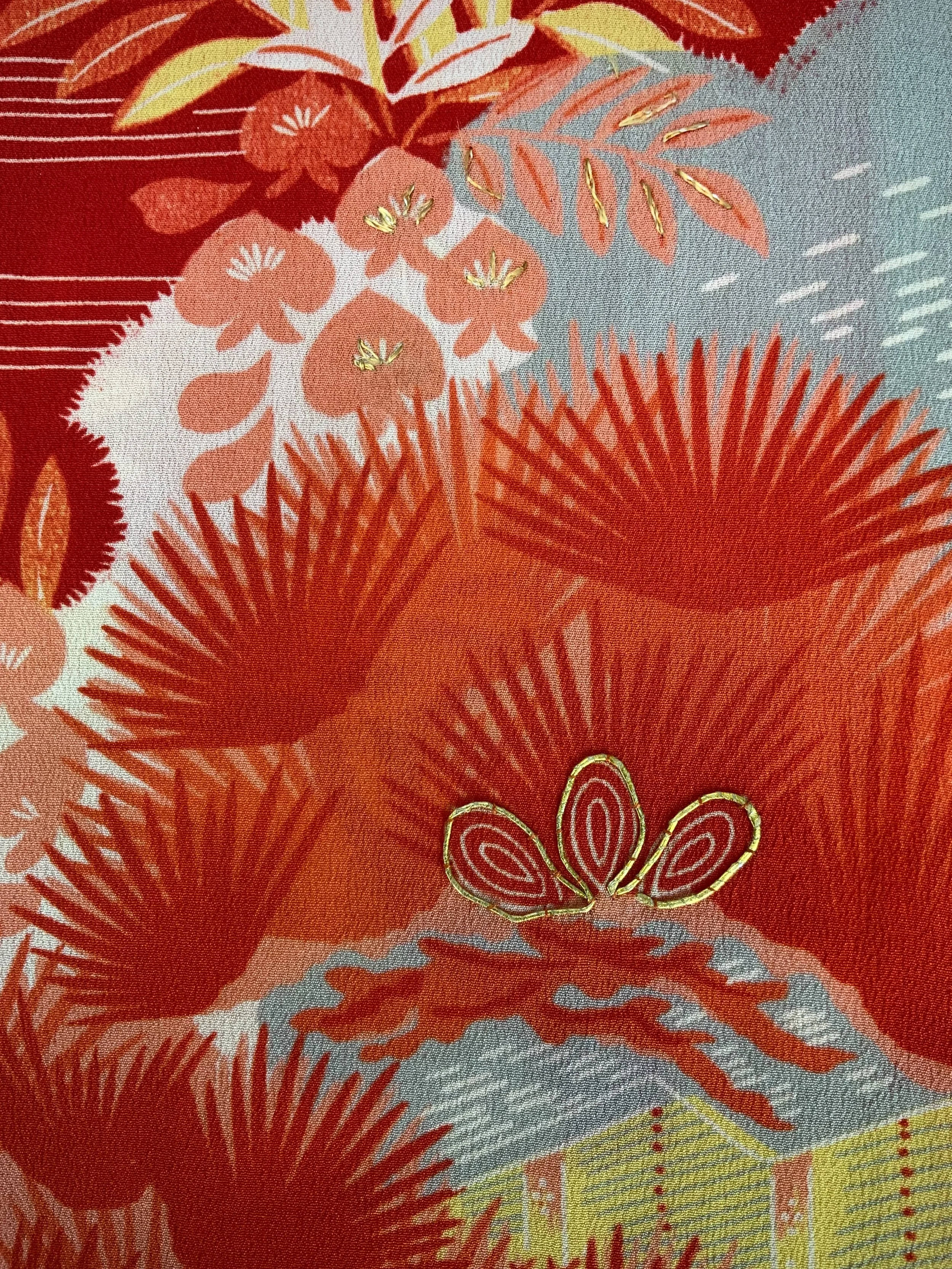 Closeup of vibrant red and yellow scarf with printed blossom design, handmade from repurposed Japanese kimono crepe silk by Kirsty Chivers