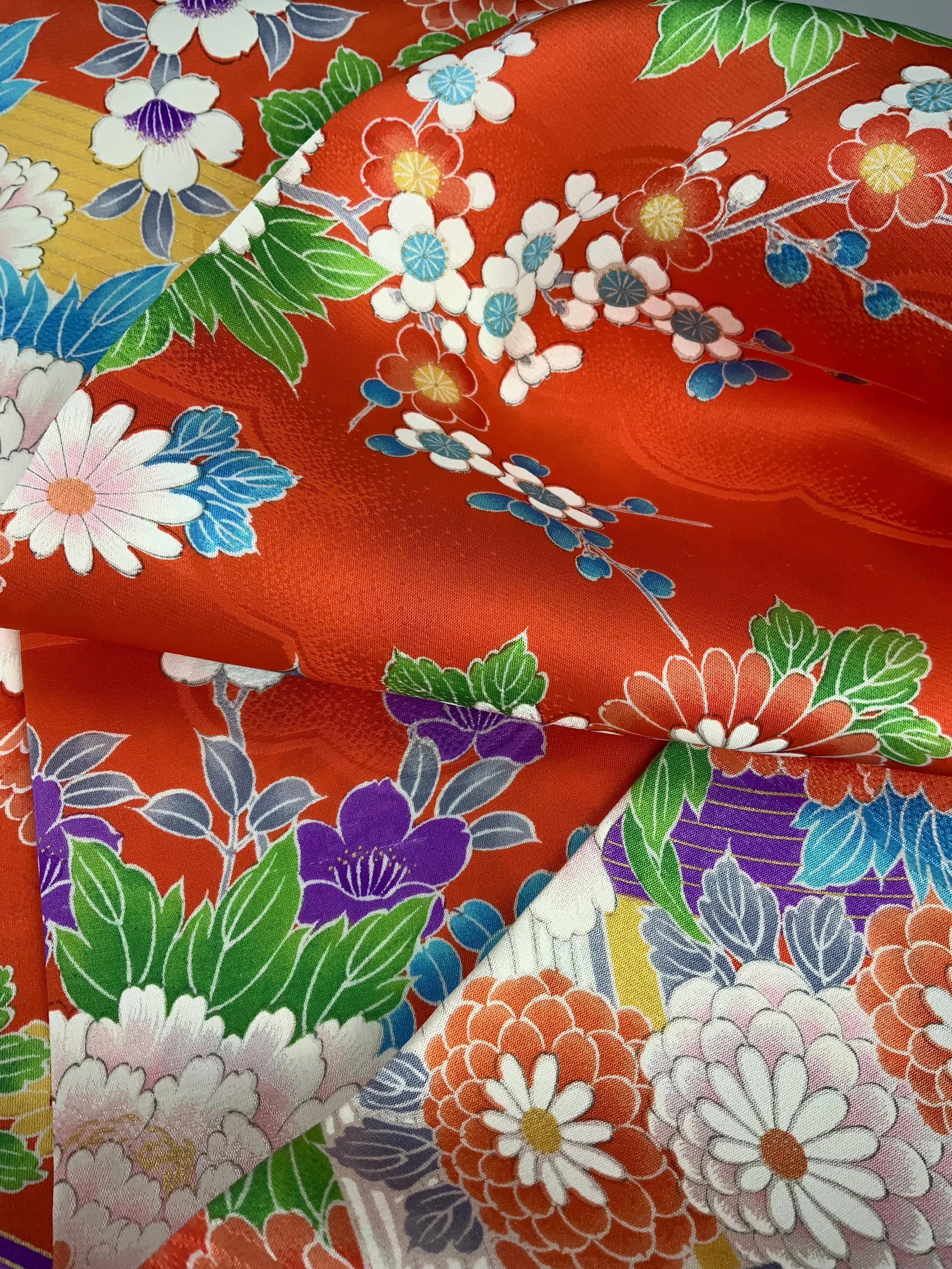 Closeup of orange scarf with blossom print made from rinzu kimono silk by Kirsty Chivers