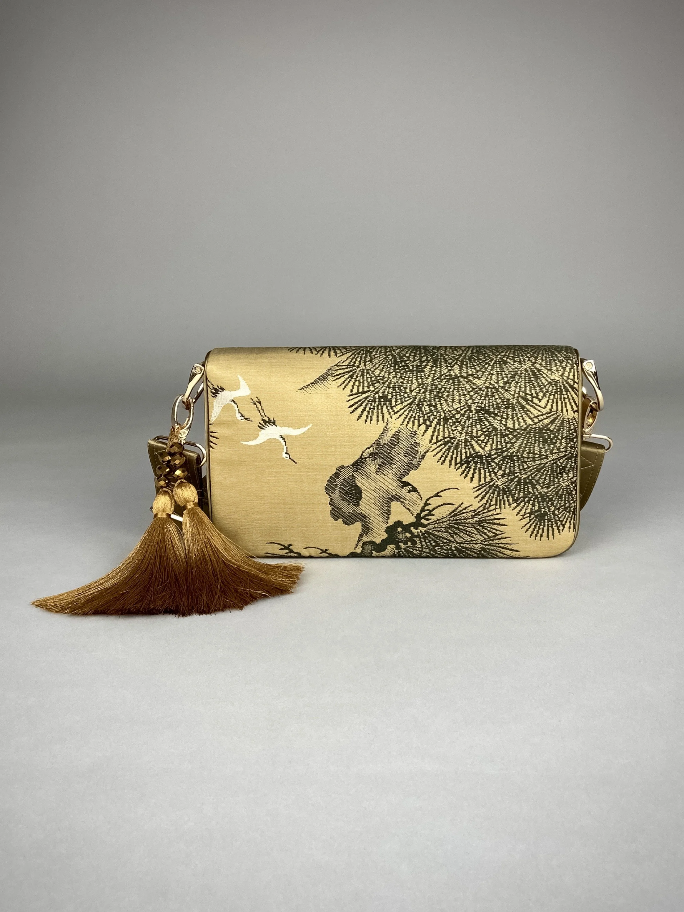 Unique Matsu pine baguette bag, made from vintage Japanese obi silk, with crane design, gold hardware and matching tassel charms by Kirsty Chivers