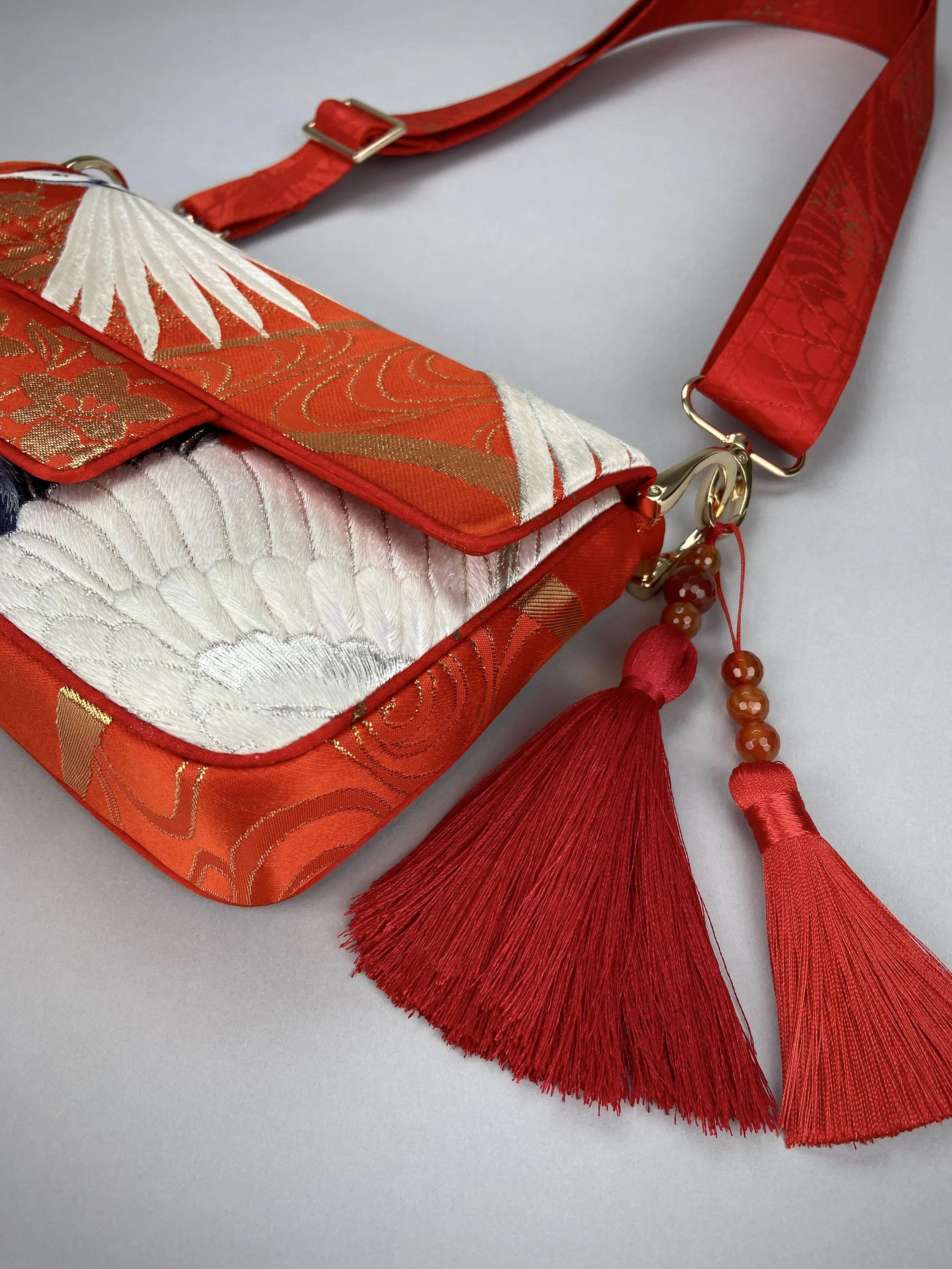 Vermillion Crane Feather baguette bag, made from vintage Japanese kimono silk, with gold hardware and Agate beaded tassel charms by Kirsty Chivers