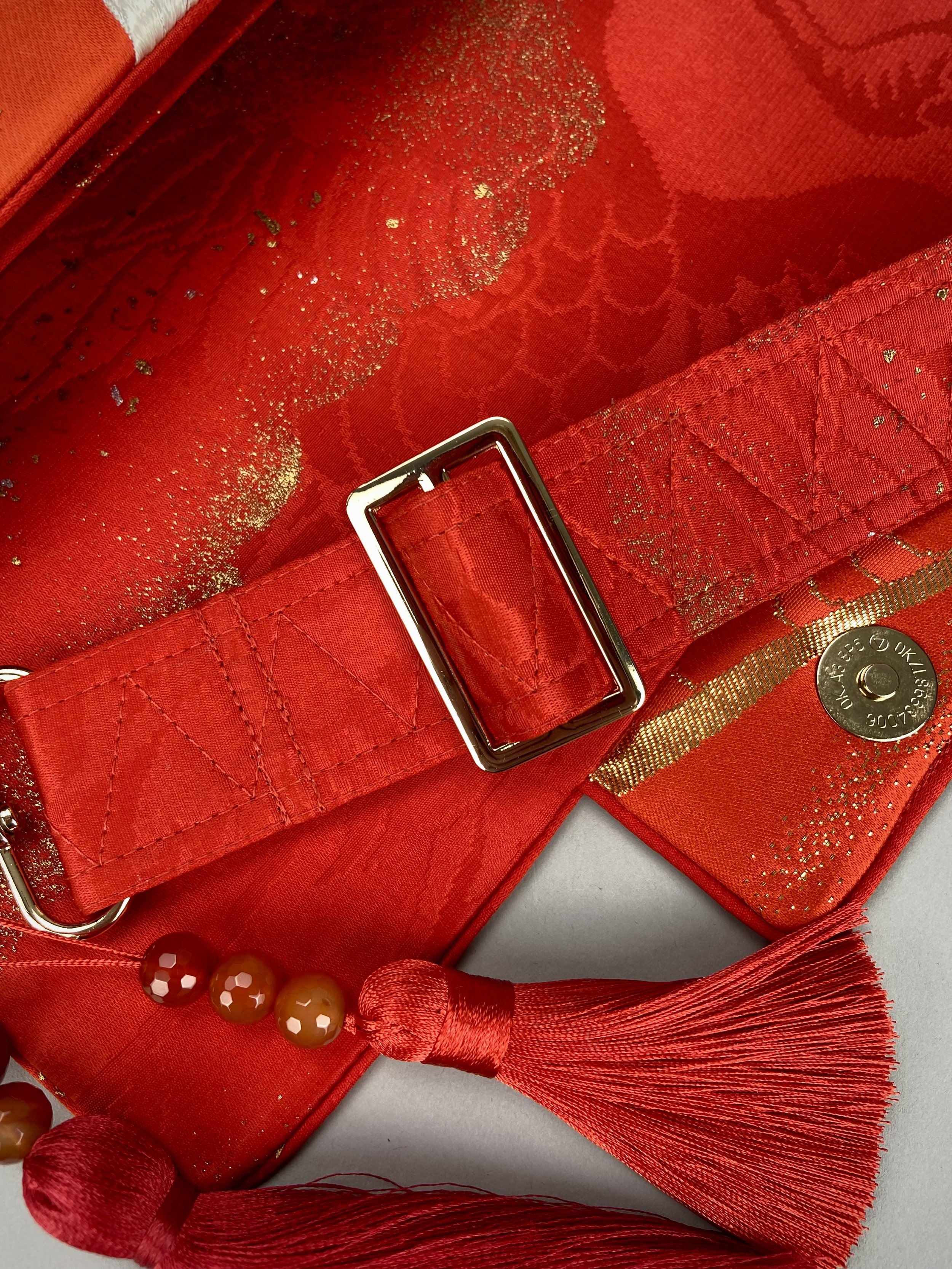 Vermillion Crane Feather baguette bag, made from vintage Japanese kimono silk, with gold hardware and Agate beaded tassel charms by Kirsty Chivers