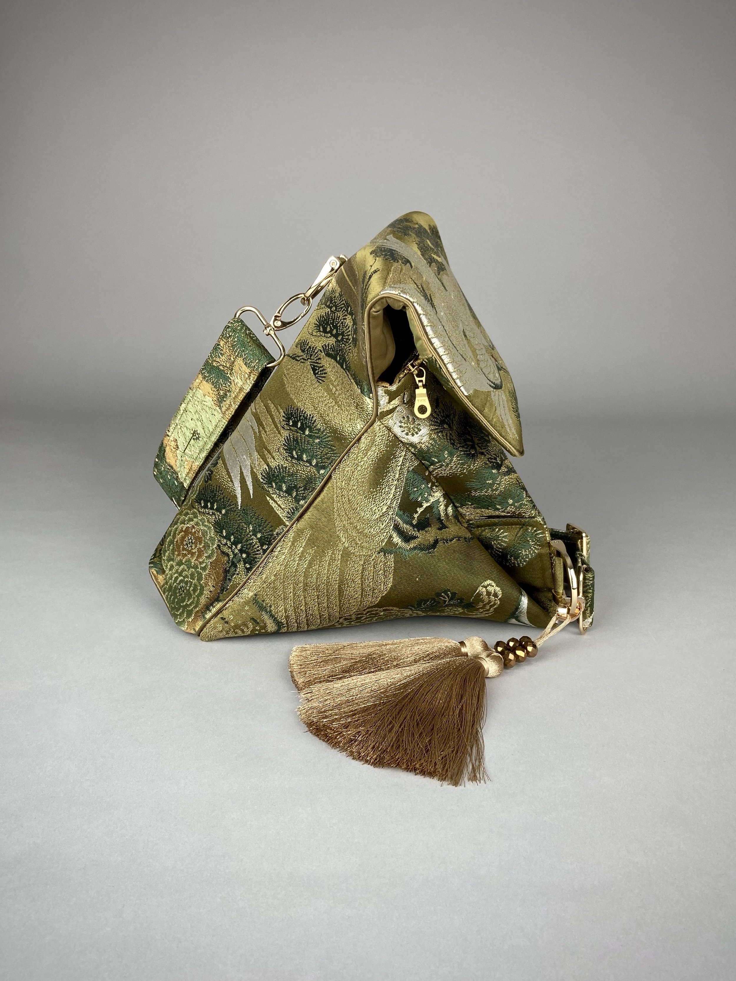 Green and gold vintage obi silk shoulder bag with crane, pine and chrysanthemum design, gold hardware and matching fabric tassel charm by Kirsty Chivers