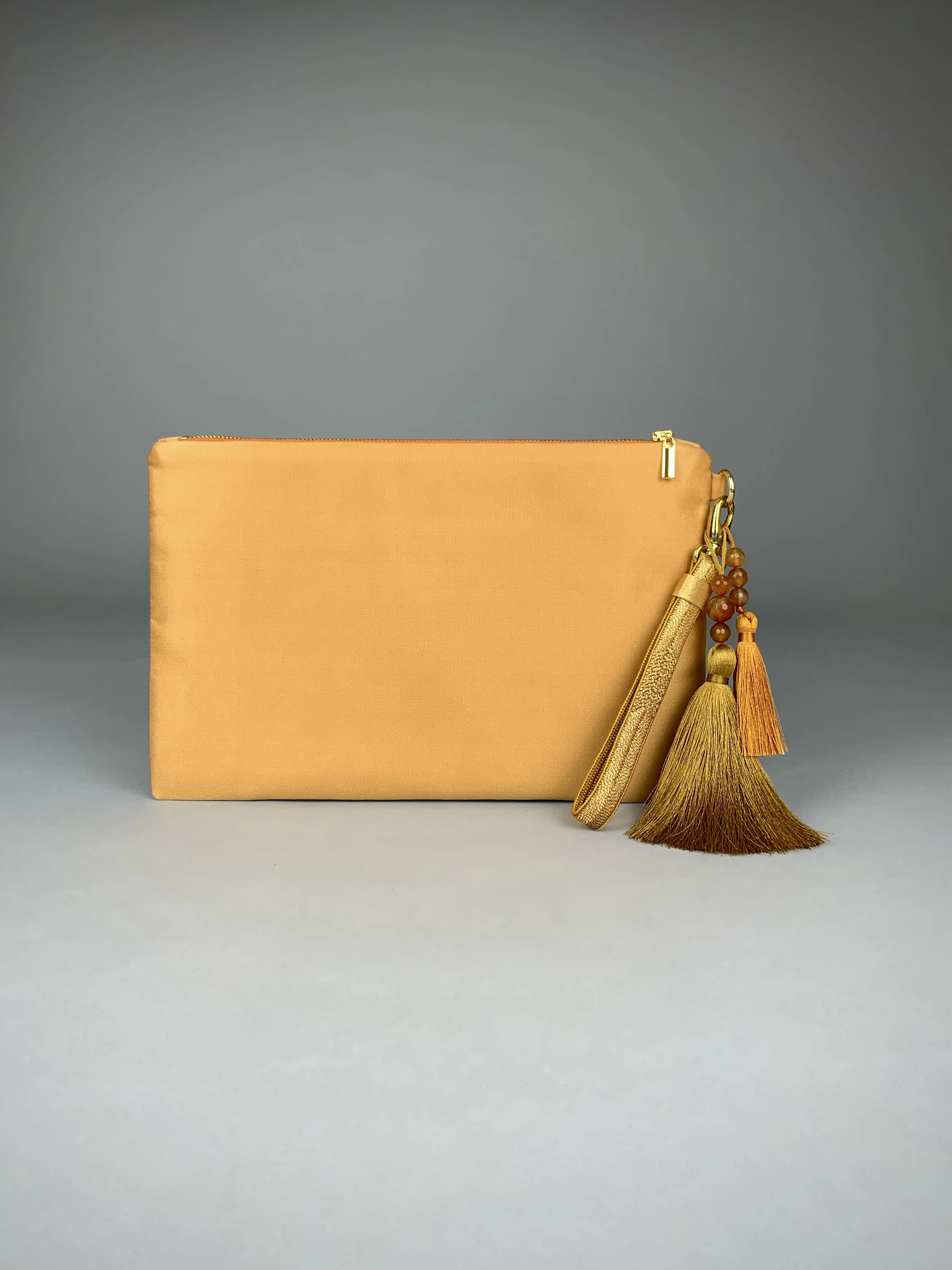 Back view of glittery gold clutch with abstract leaf design. Handmade from vintage obi silk by Kirsty Chivers