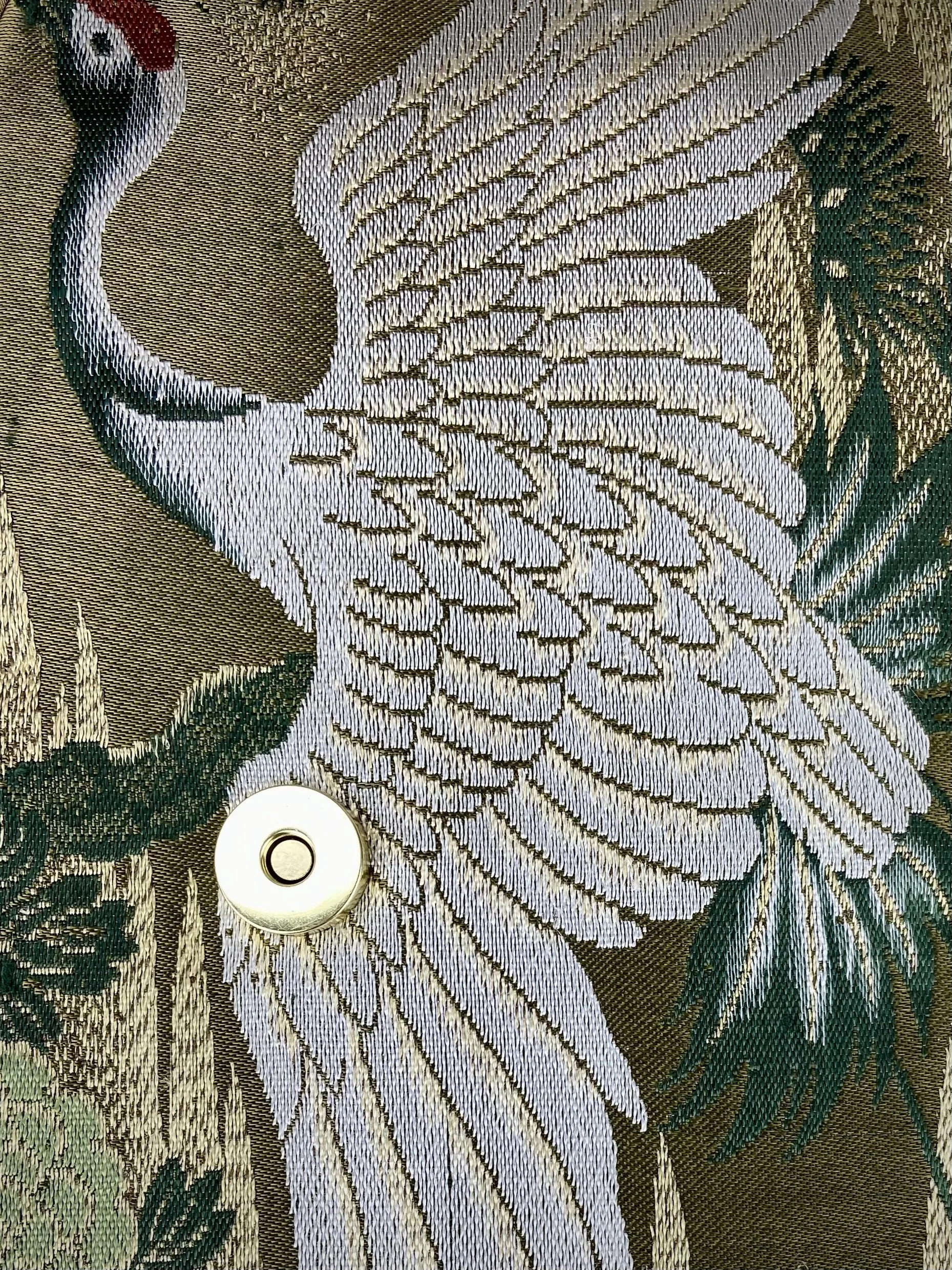 Unique Flying Crane baguette bag, handmade from vintage Japanese obi silk with gold hardware and matching silk tassel charm by Kirsty Chivers