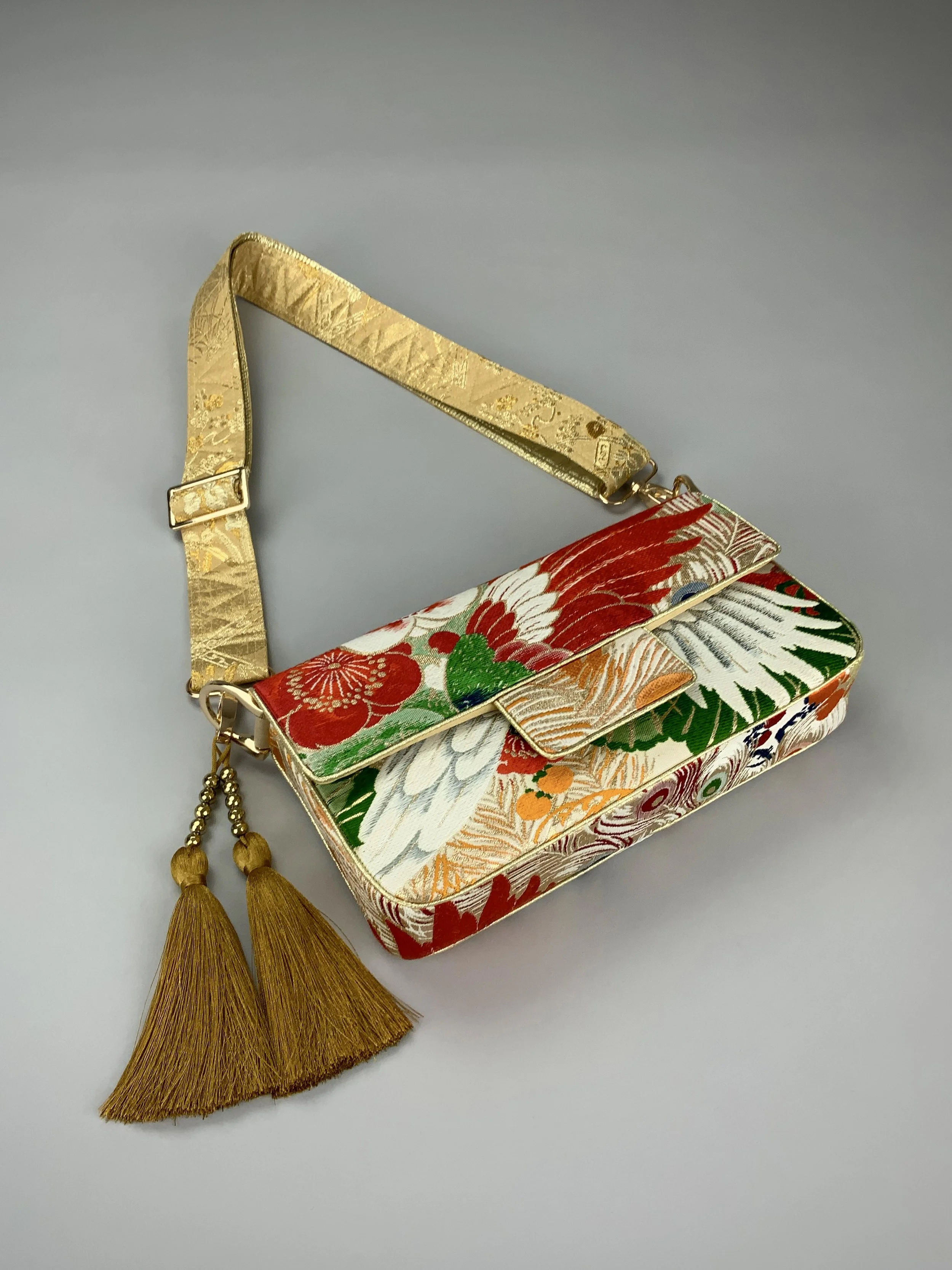 Unique evening bag in vintage obi silk with peacock, pine motifs & gold accents by Kirsty Chivers