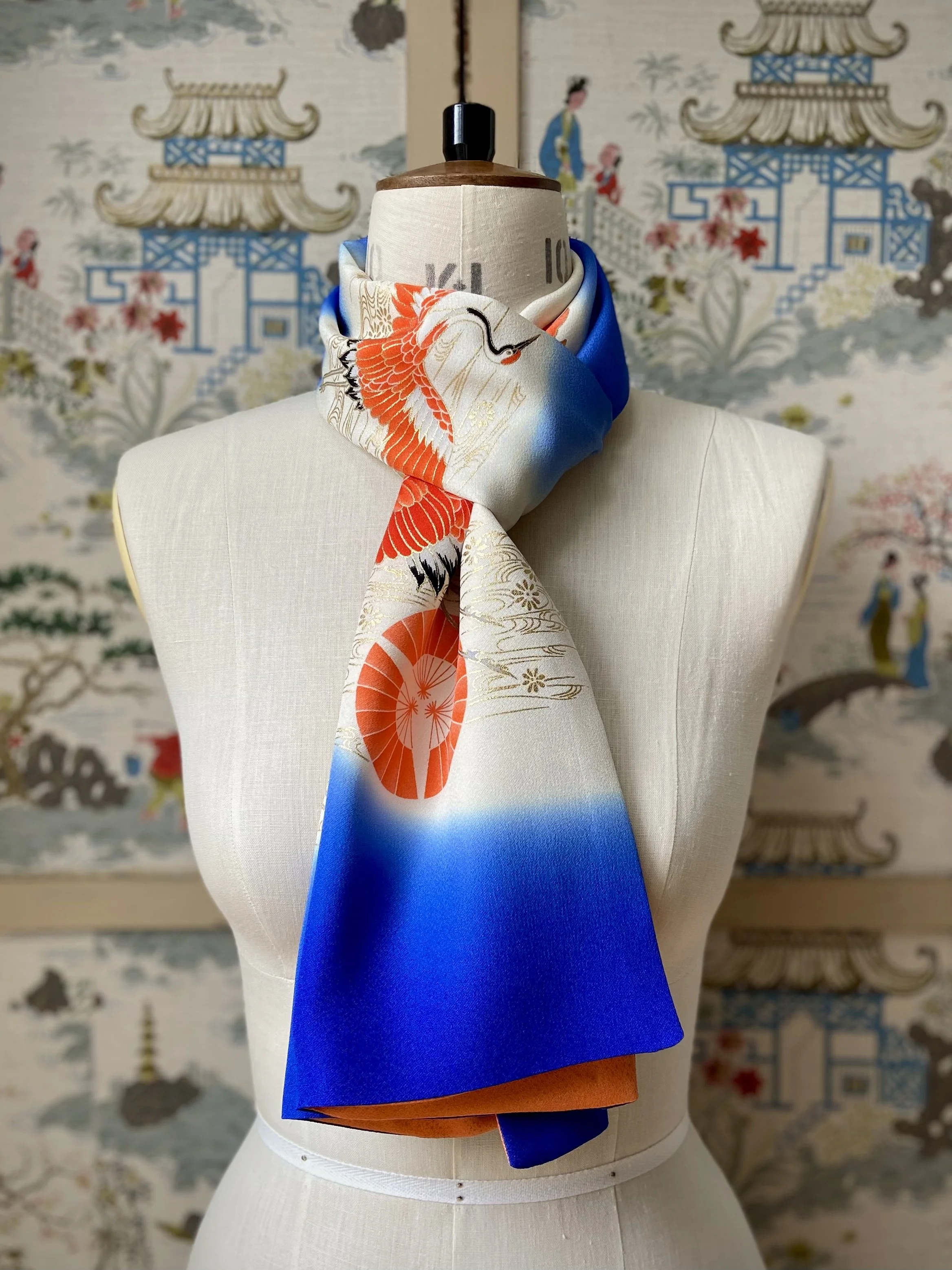 Blue silk scarf, presented on a dress stand, with printed Flying Crane design handmade by Kirsty Chivers