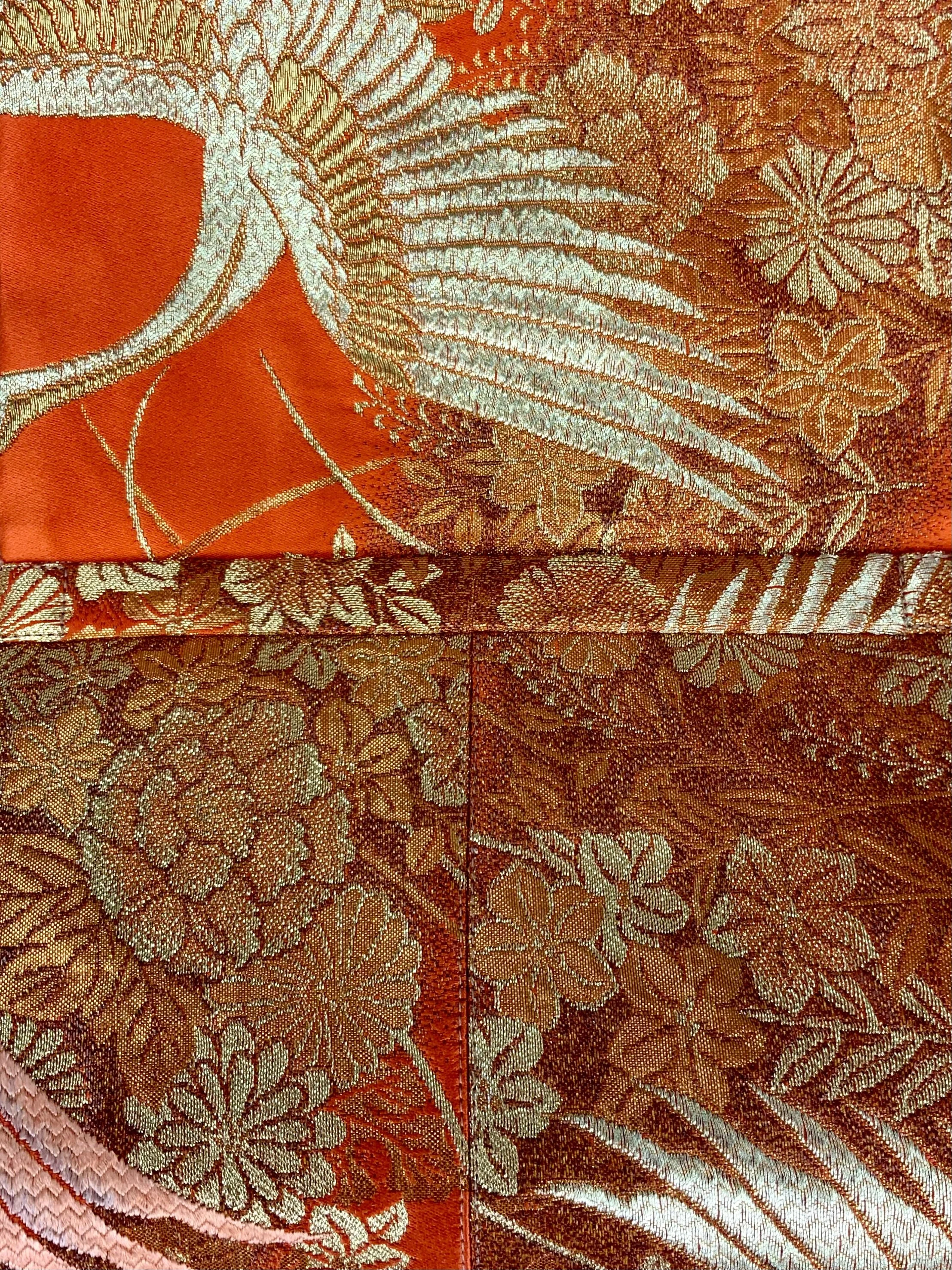 Vibrant orange evening bag with gold copper crane and blossom design, handmade from vintage obi silk by Kirsty Chivers